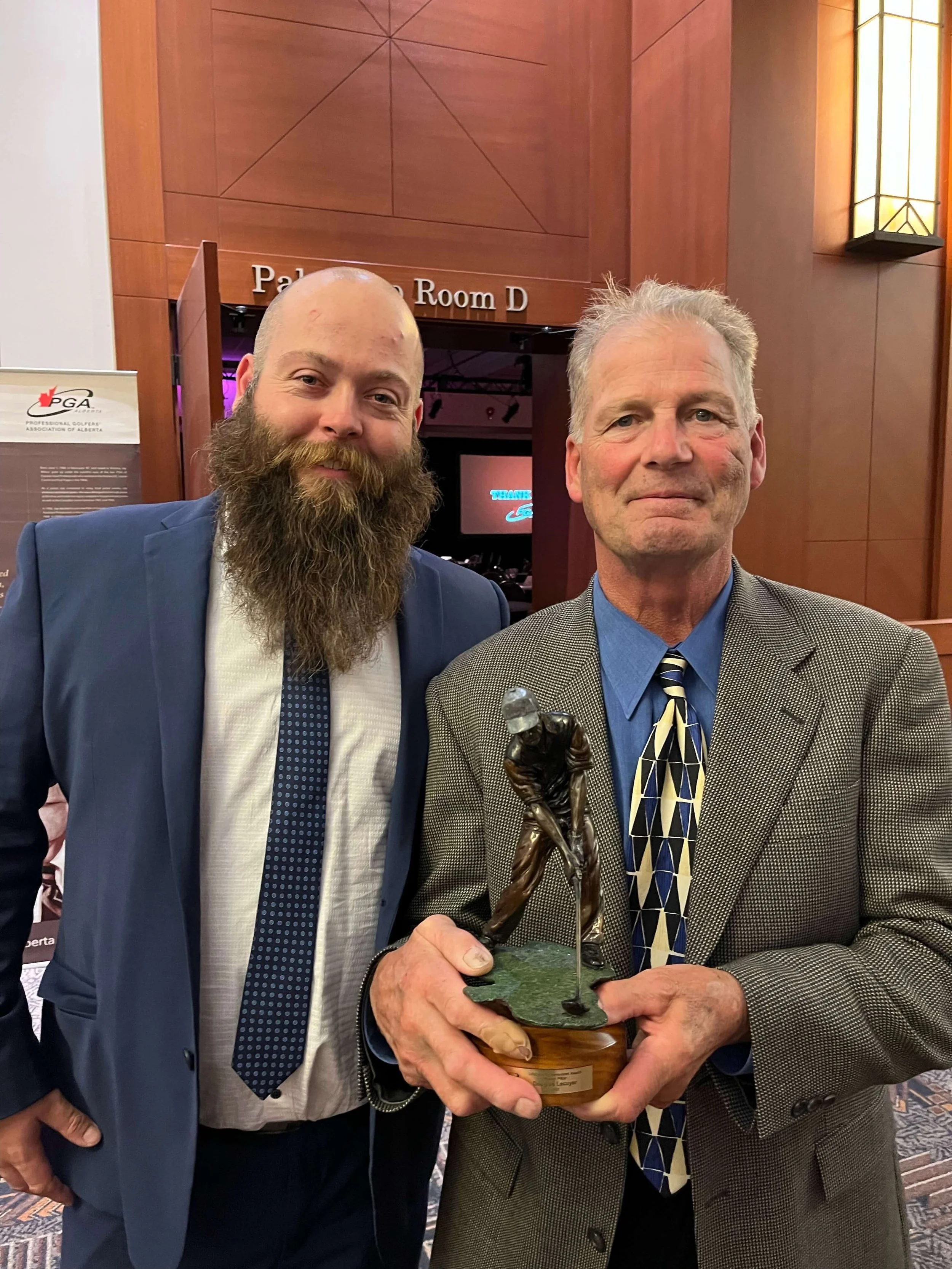 Hawks winger Doug Lecuyer later became a golf pro. Here he is with son Jake while being presented a lifetime achievement award by the Alberta PGA (courtesy Doug Lecuyer)