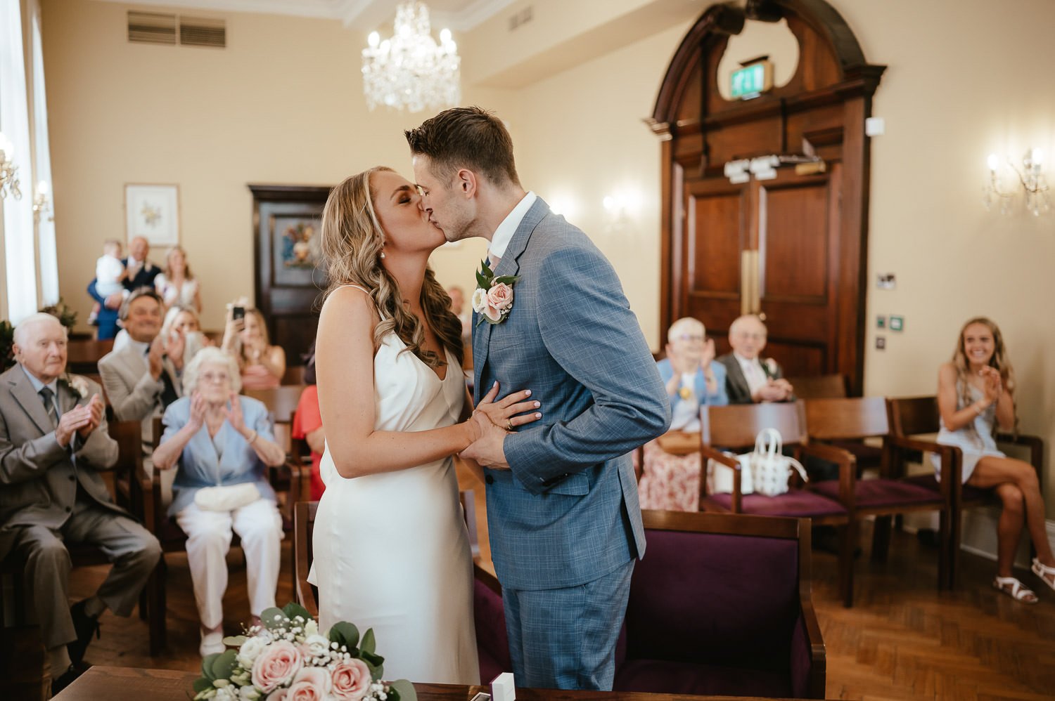 bride and groom kiss at town hall wedding