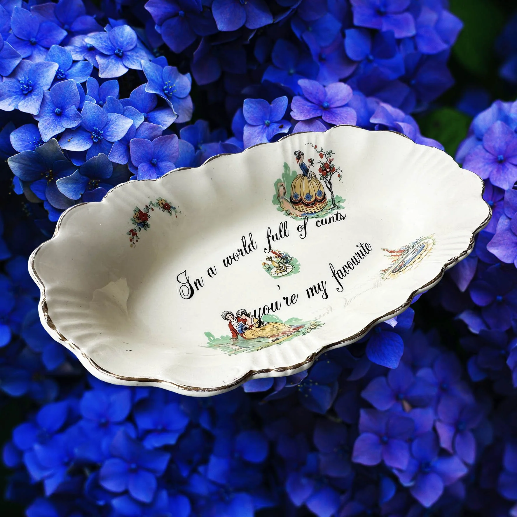 A vintage trinket dish with the quote “In a world full of cunts you’re my favourite”