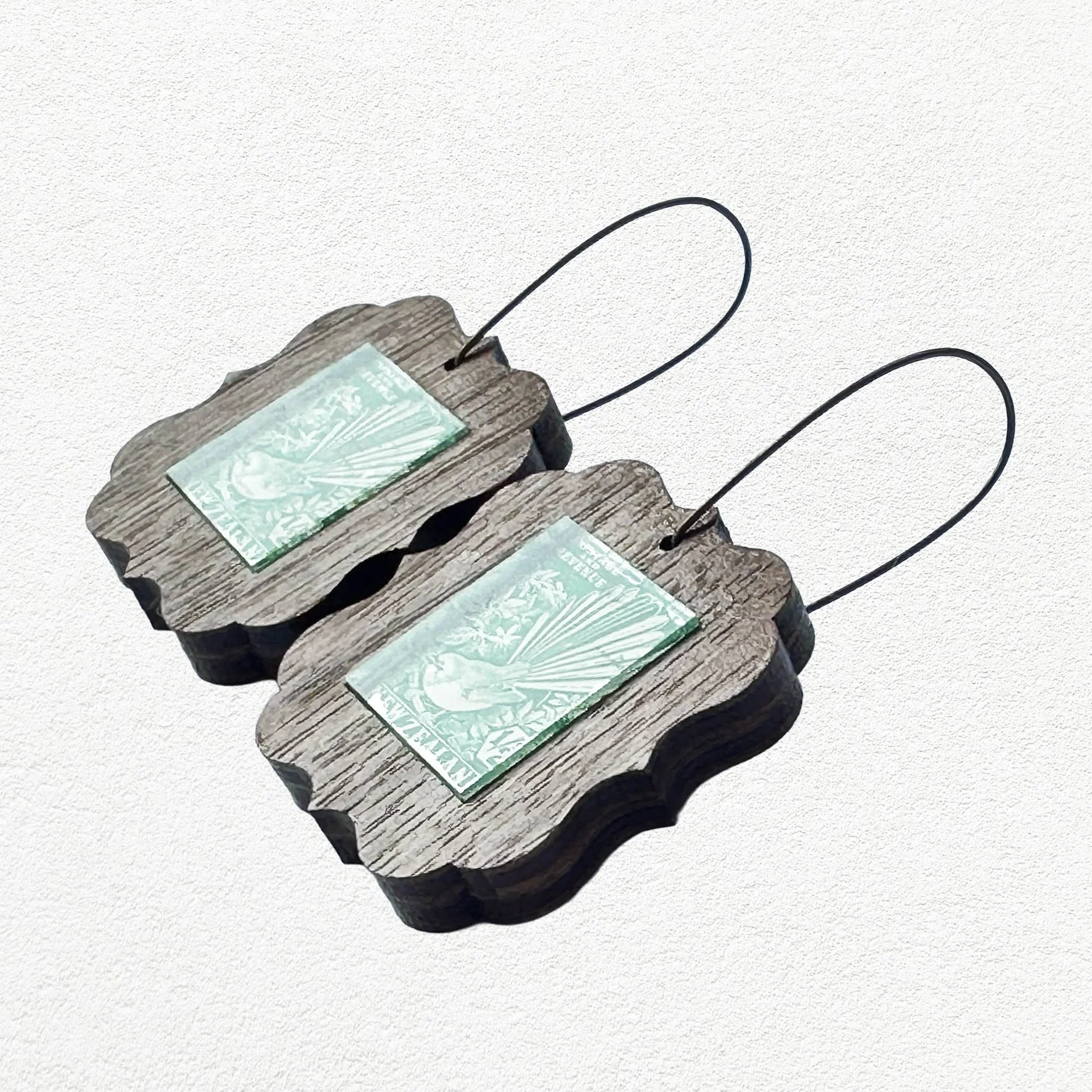 Wooden earings featuring vintage New Zealand Fantail postage stamps.