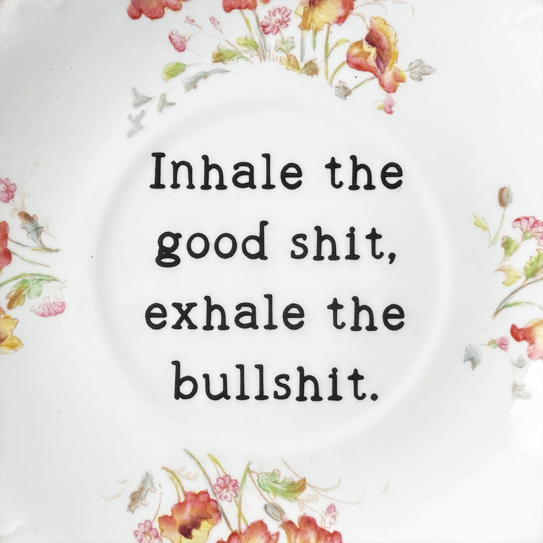 A vintage plate with a quote “inhale the good shit, exhale the bullshit”