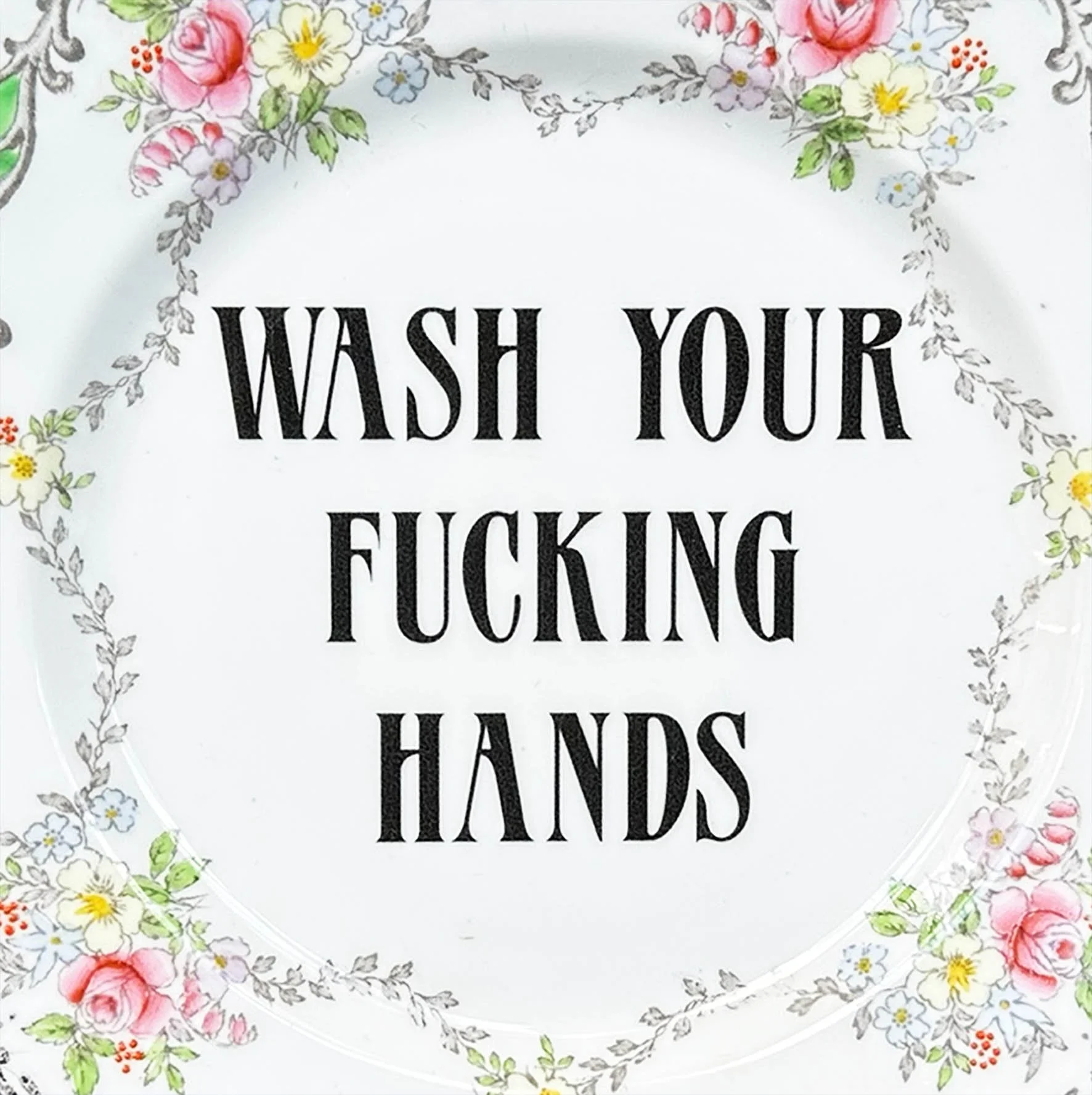A decorative plate with the quote “wash your fucking hands”