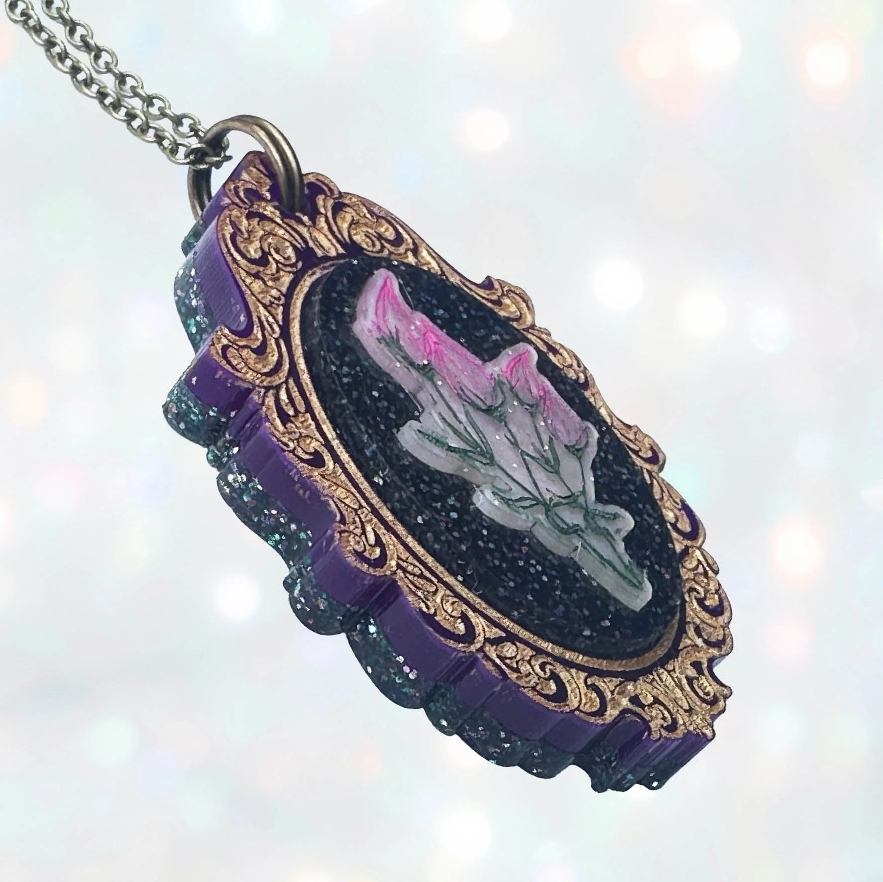Laser cut acrylic cameo necklace featuring a bunch of flowers inside a gold frame
