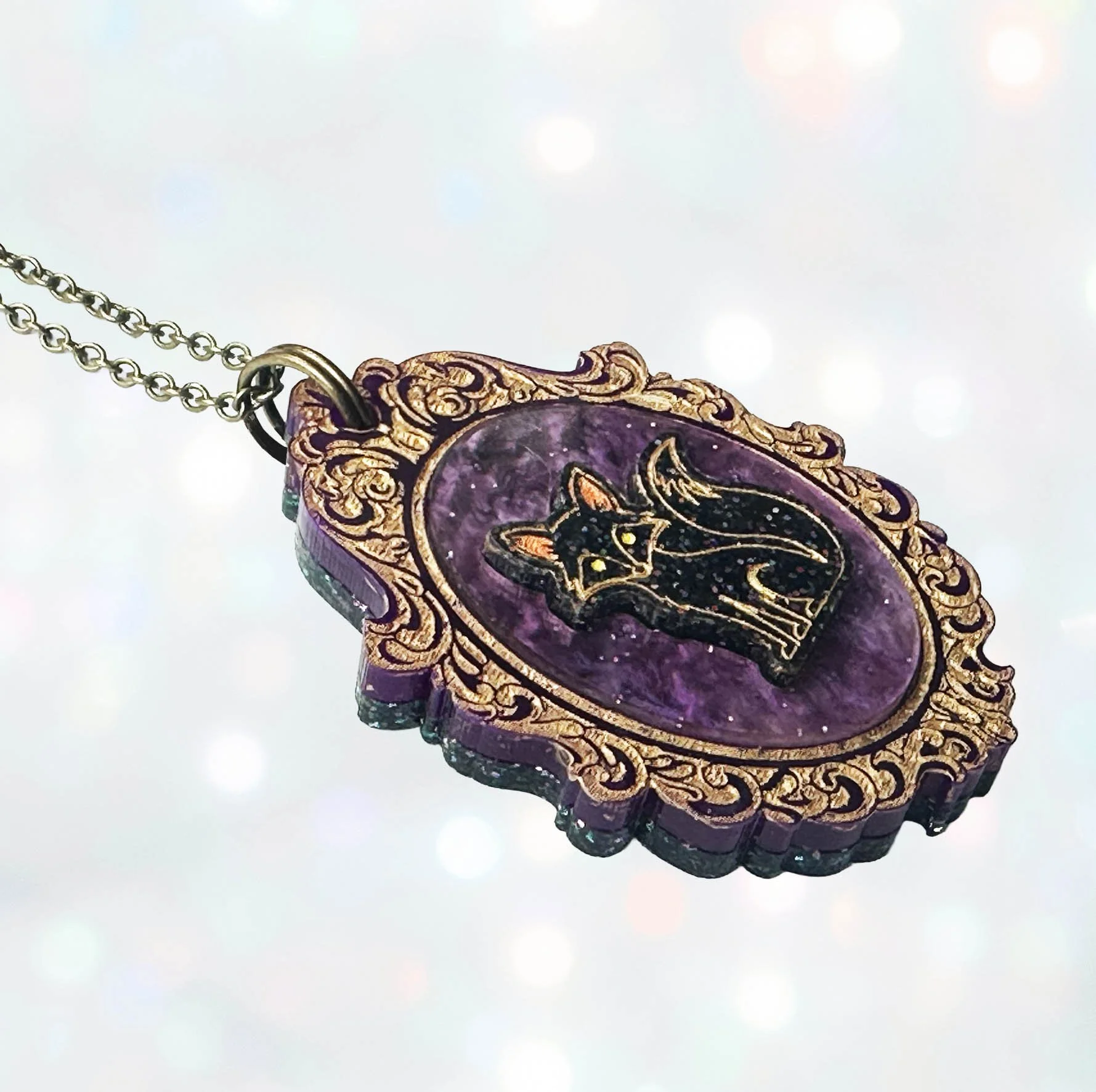 A laser cut cameo style necklace featuring a fox inside a gold frame