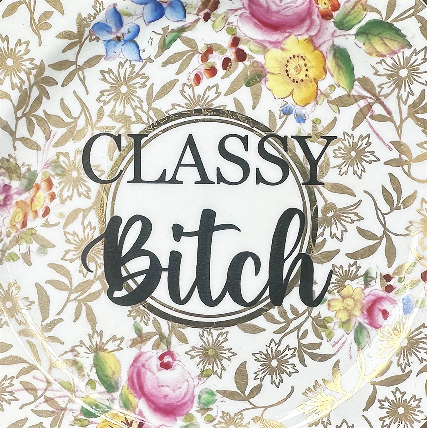 A vintage plate with a gold and pink floral design and the words "classy bitch" in black writing
