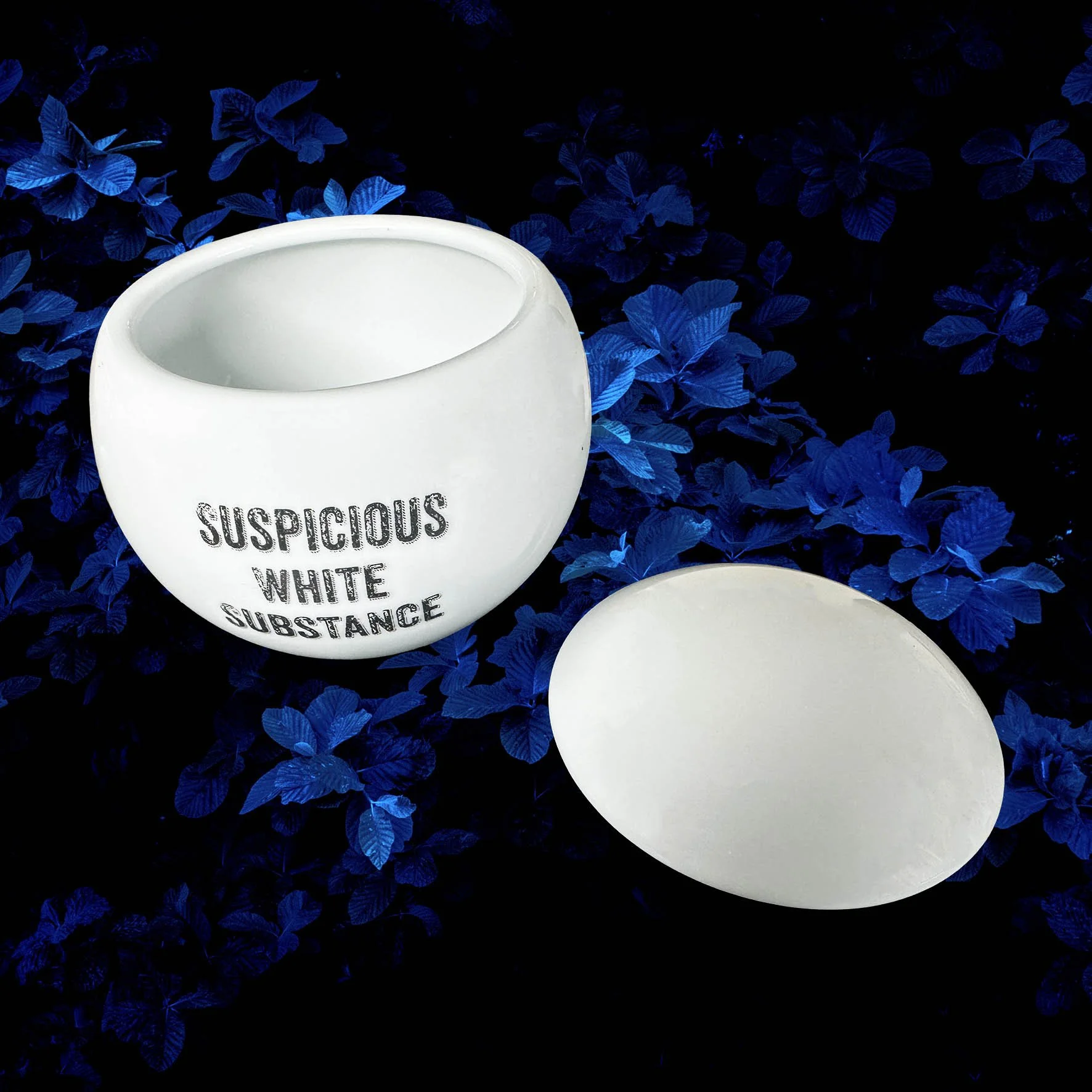 A round white sugar bowl with the words "suspicious white substance" in black lettering