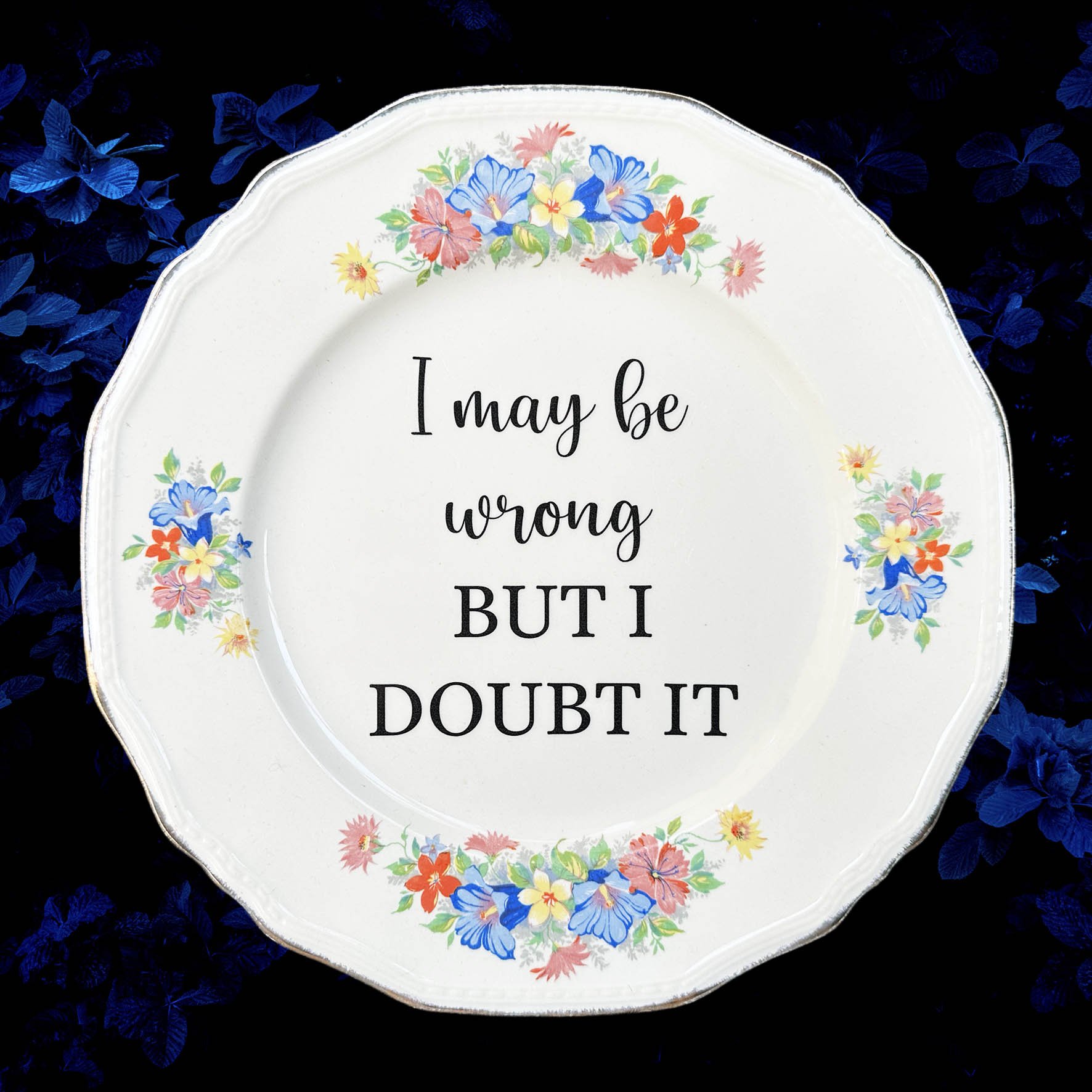 A vintage plate with a funny quote "I may be wrong but I doubt it"