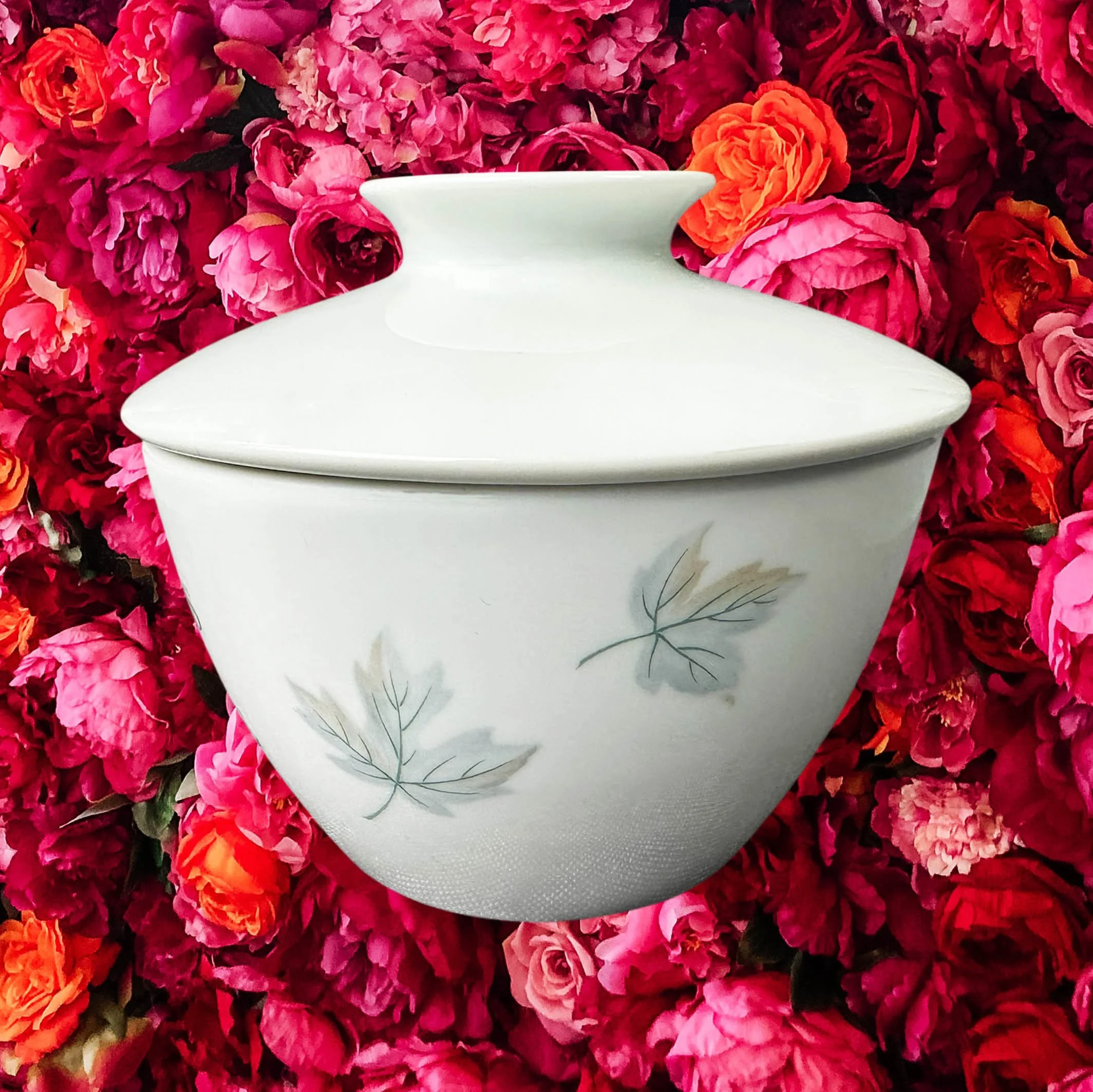 A vintage Noritake sugar bowl with a maple leaf design and the words “suspicious white substance” in black lettering