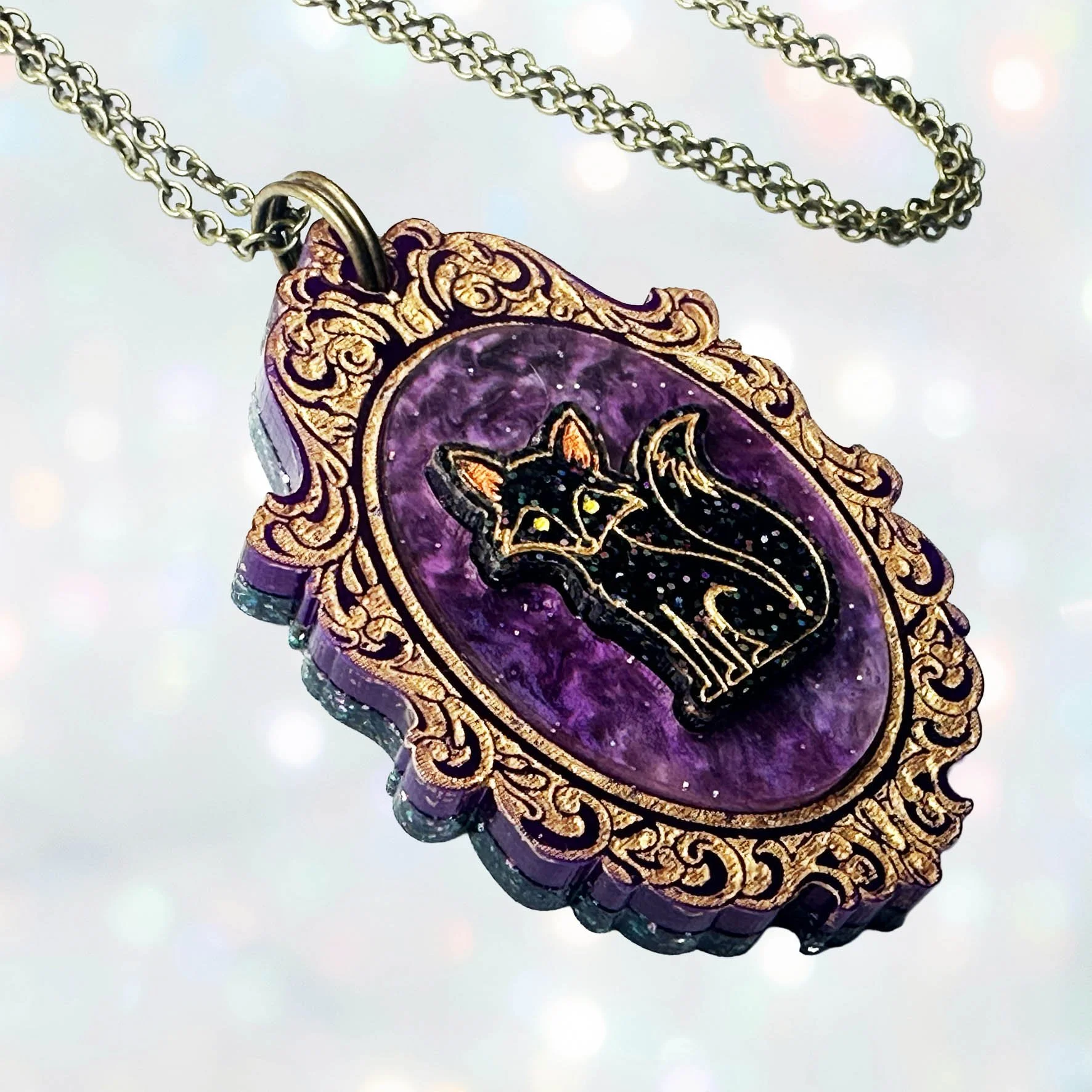 A laser cut cameo style necklace featuring a fox inside a gold frame