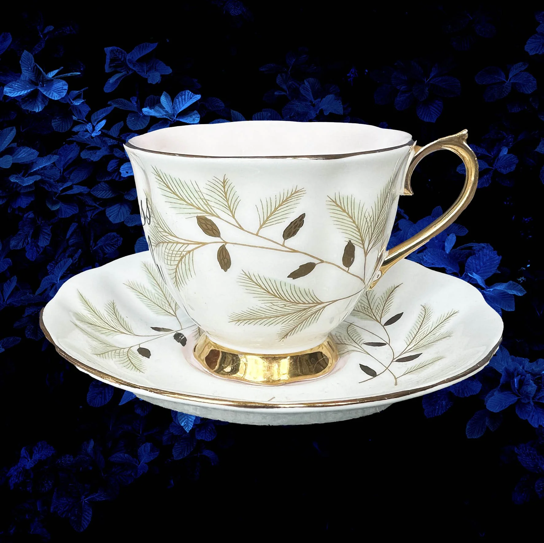 A vintage tea cup with a floral design with the quote “badass bitch”