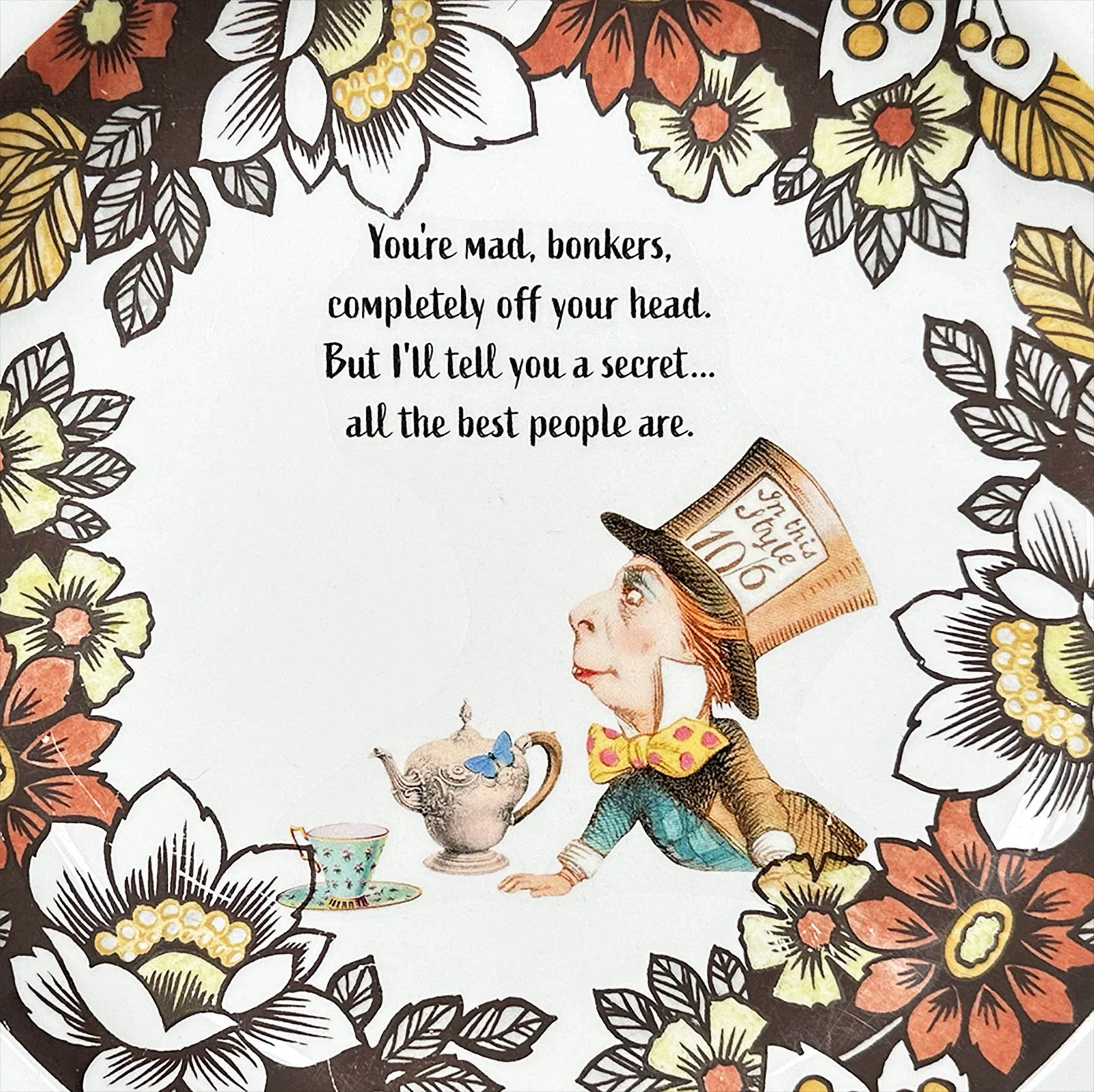 A vintage plate with an orange and yellow floral design and a picture of The Mad Hatter with the quote “you’re mad, bonkers, completely off your head”