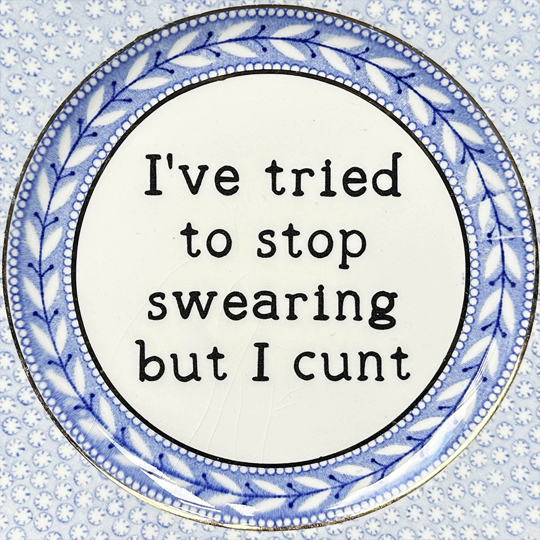A cheeky vintage plate with the quote "I've tried to stop swearing but I cunt"