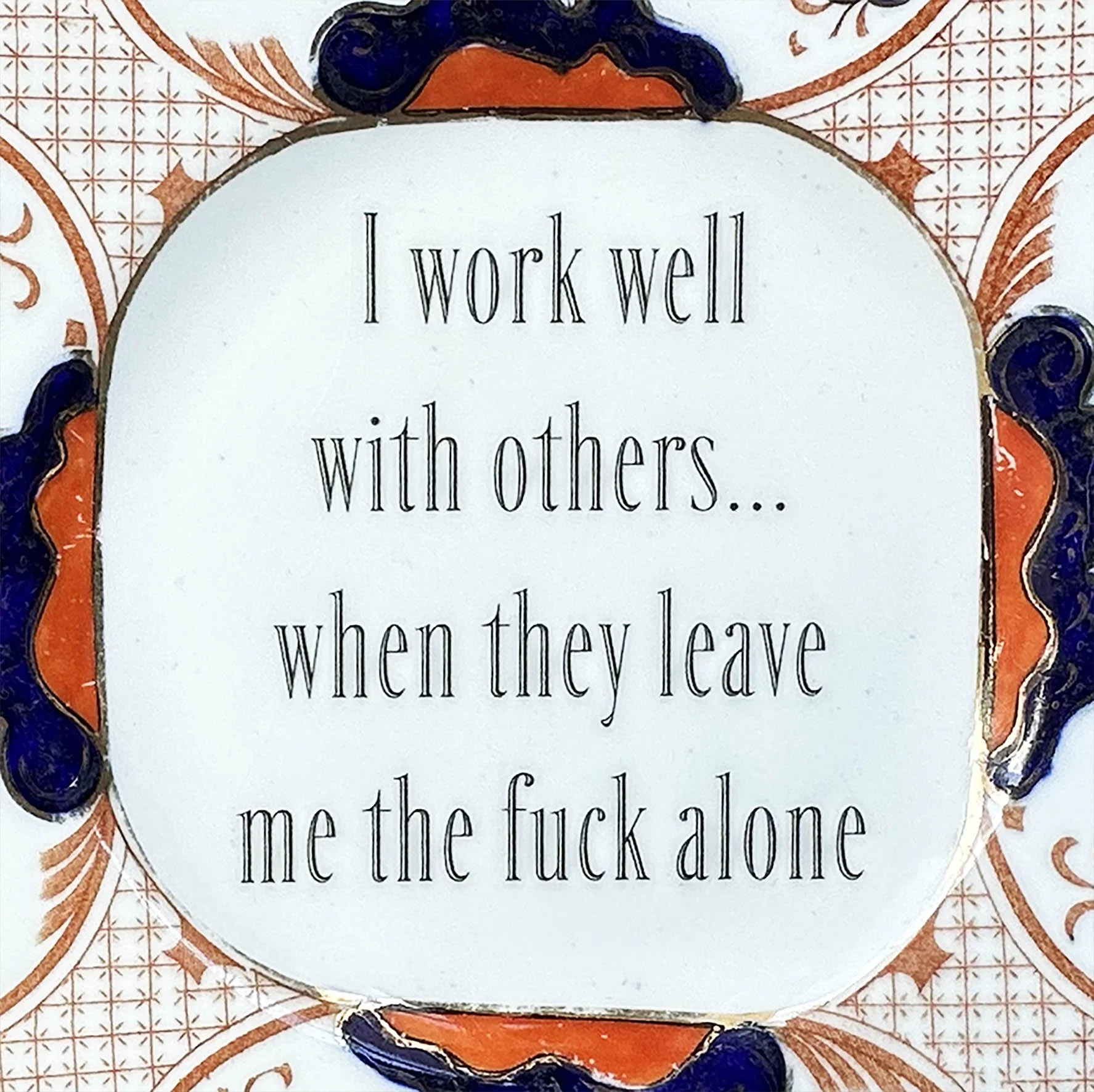 A vintage decorative plate with a cheeky quote “I work well with others…when they leave me the fuck alone”