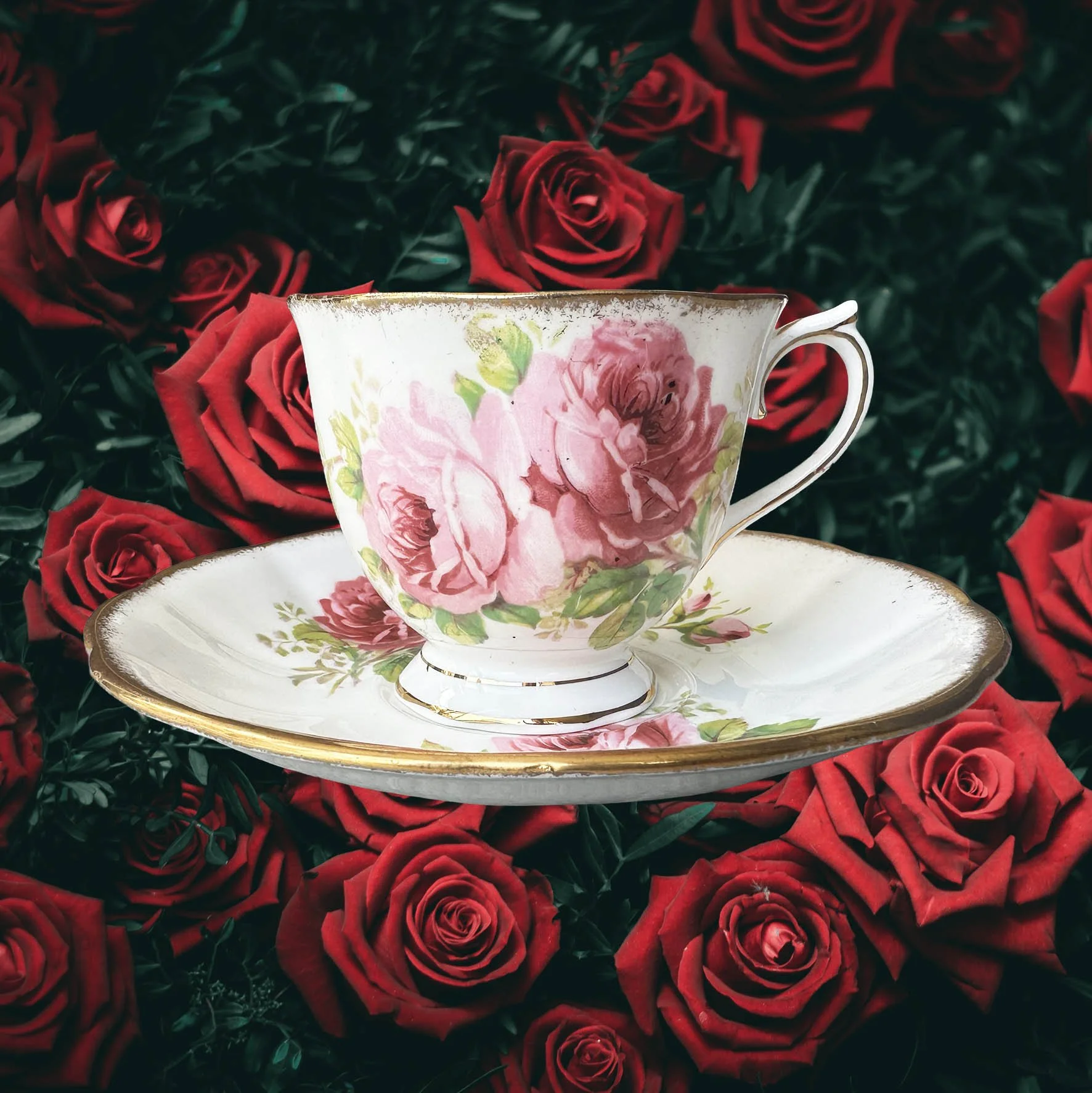A vintage tea cup with a pink floral design and the words "don't be a cunt" in black writing