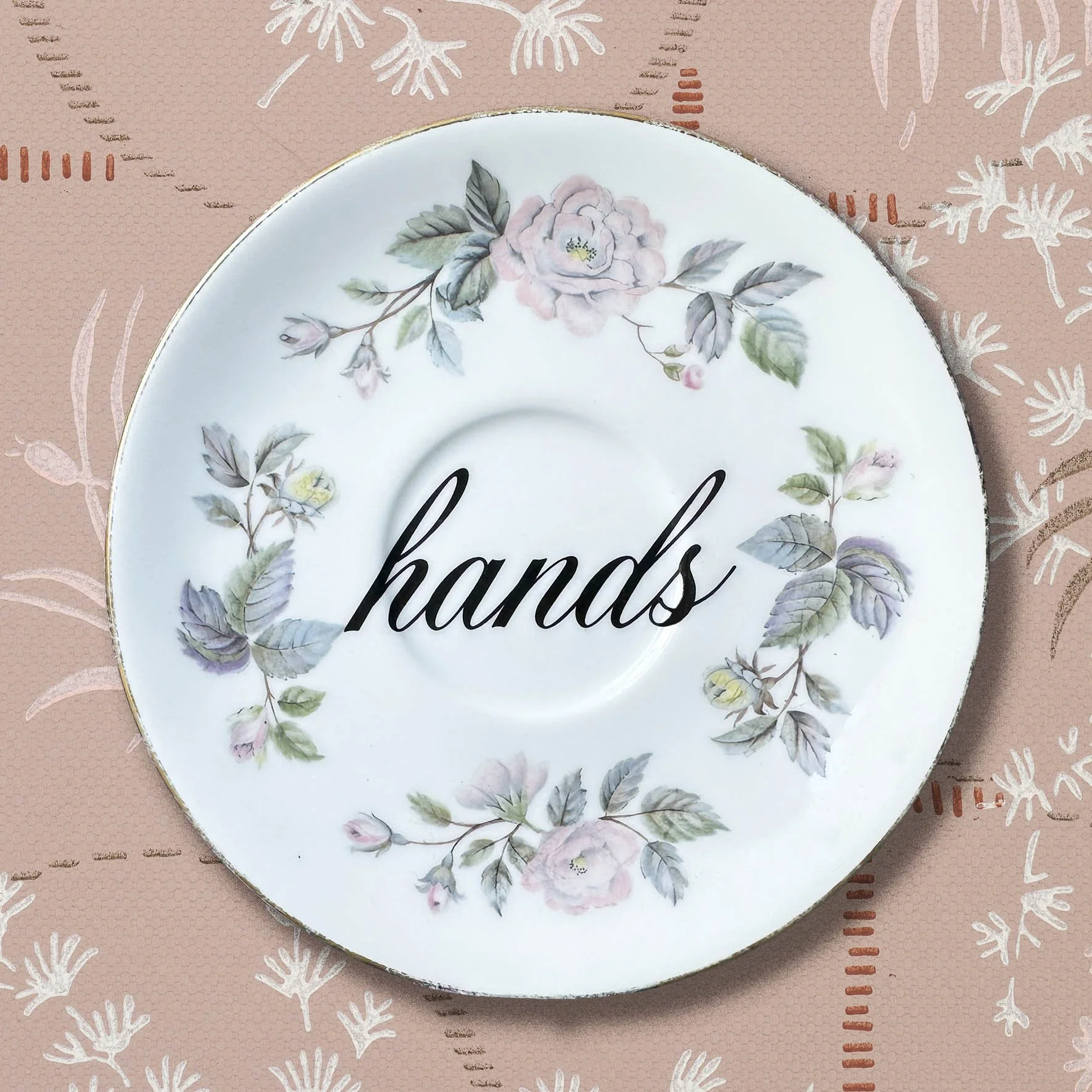 Vintage saucer with the word “hands”