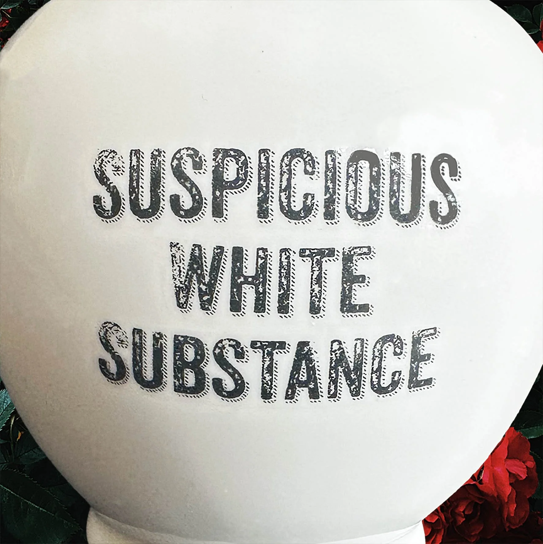A round white sugar bowl with a quote “suspicious white substance”