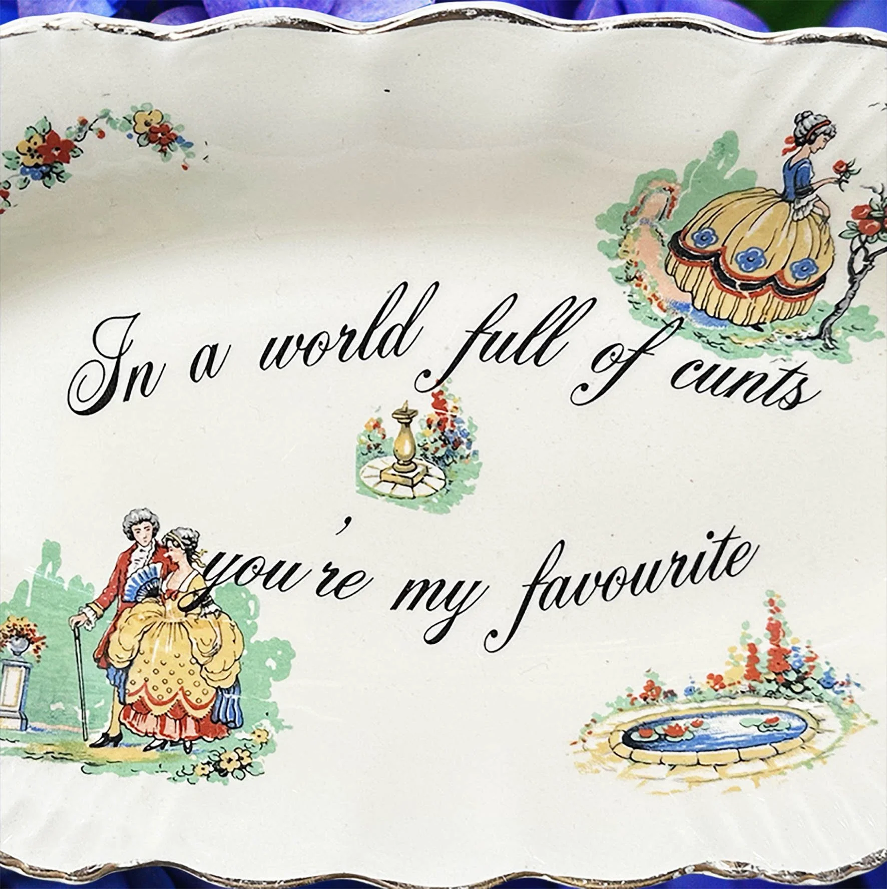 A vintage trinket dish with the quote “In a world full of cunts you’re my favourite”