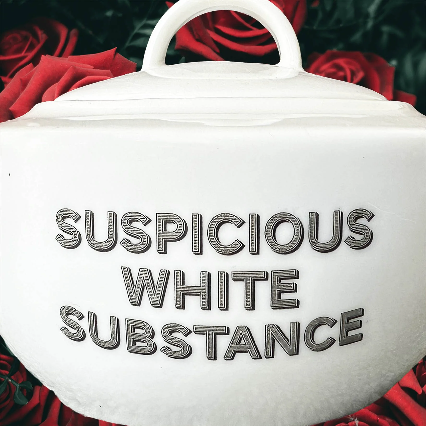 A white sugar bowl with a quote “suspicious white substance” in black lettering