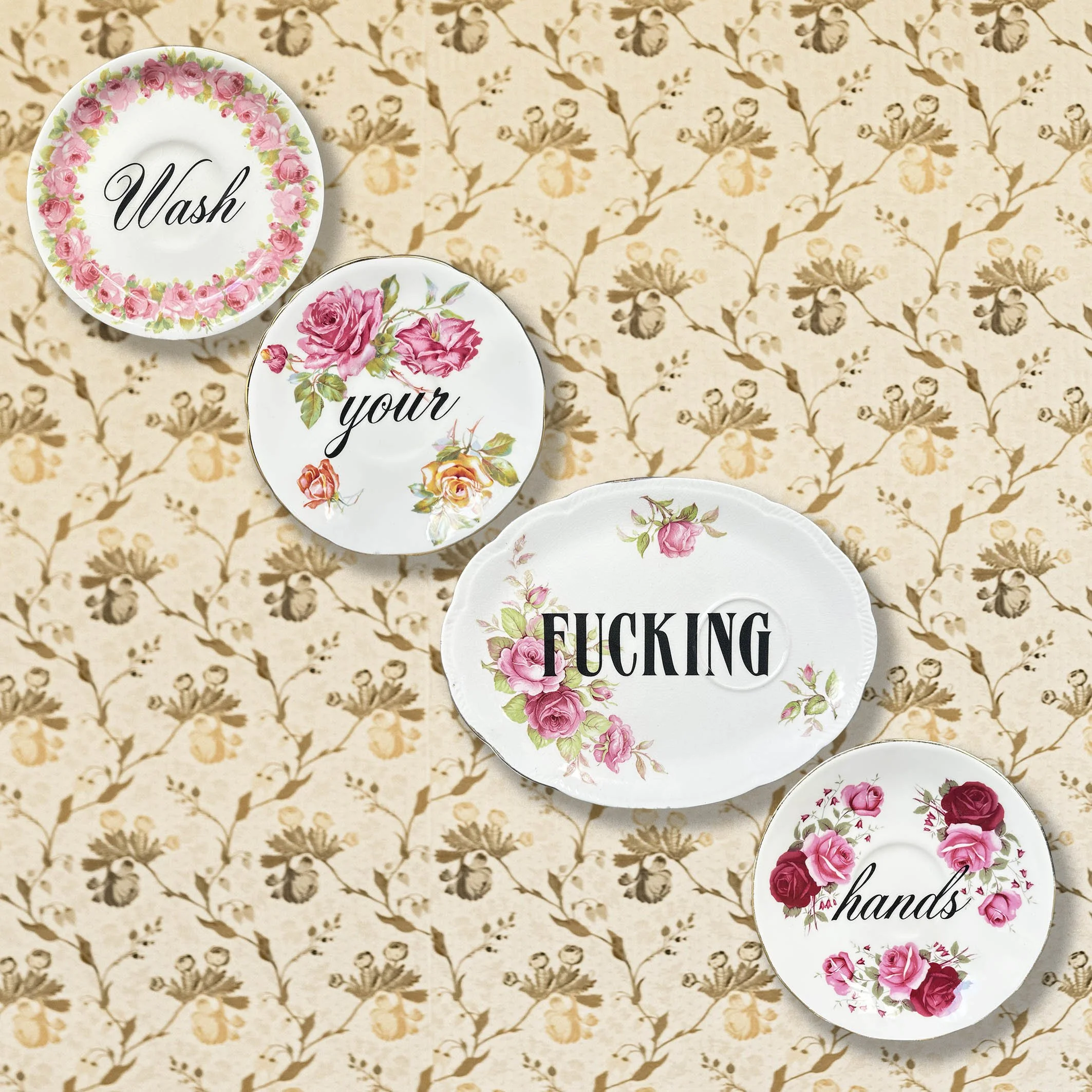 A plate set with the witty quote "wash your fucking hands"