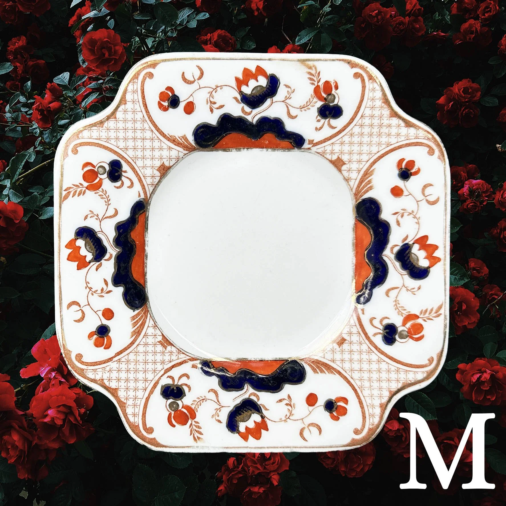 Plate M, a square vintage plate with an orange and royal blue floral design