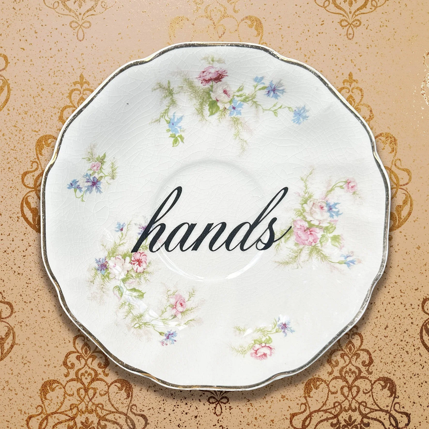 Saucer with the word “hands”
