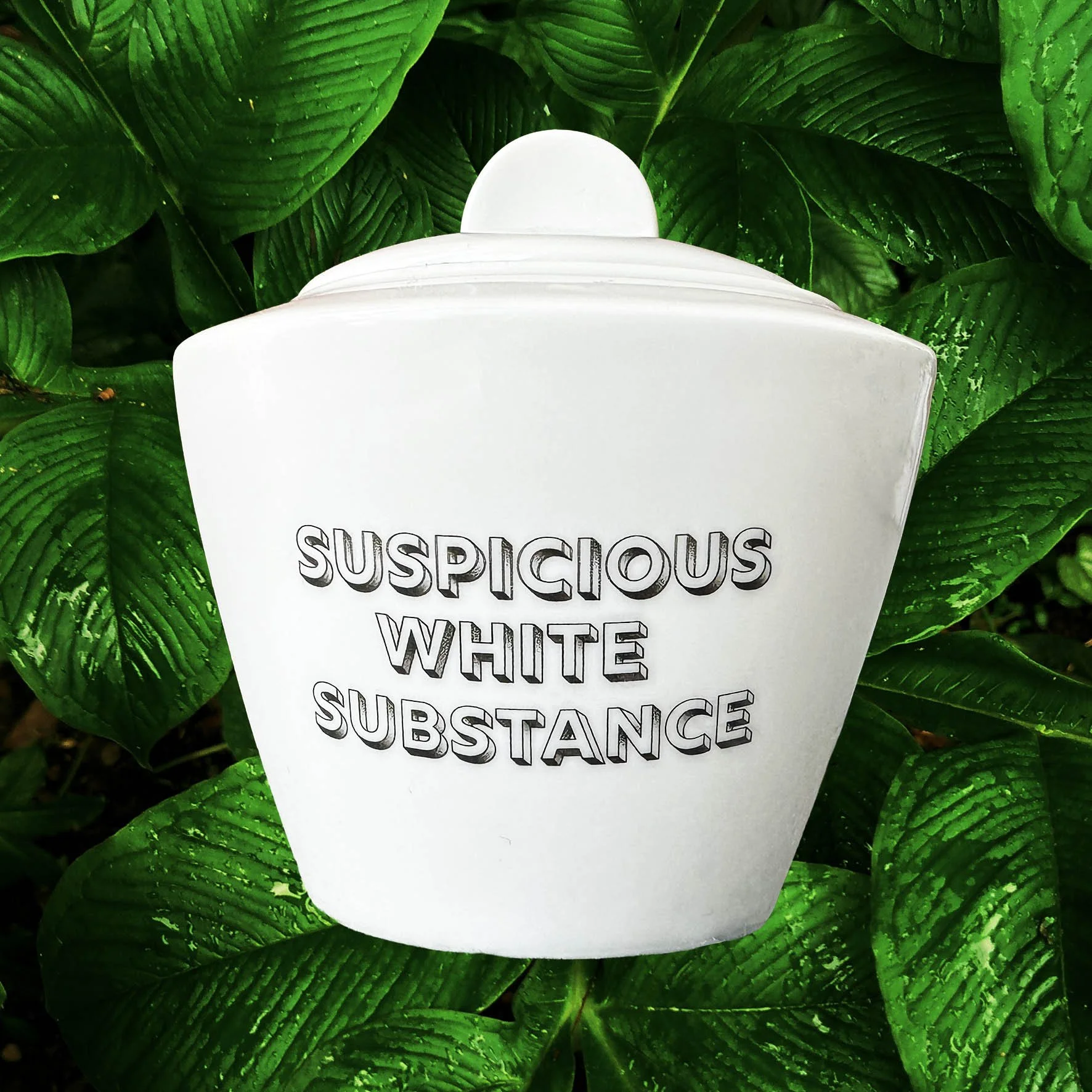 White sugar bowl with the words “suspicious white substance” in black lettering