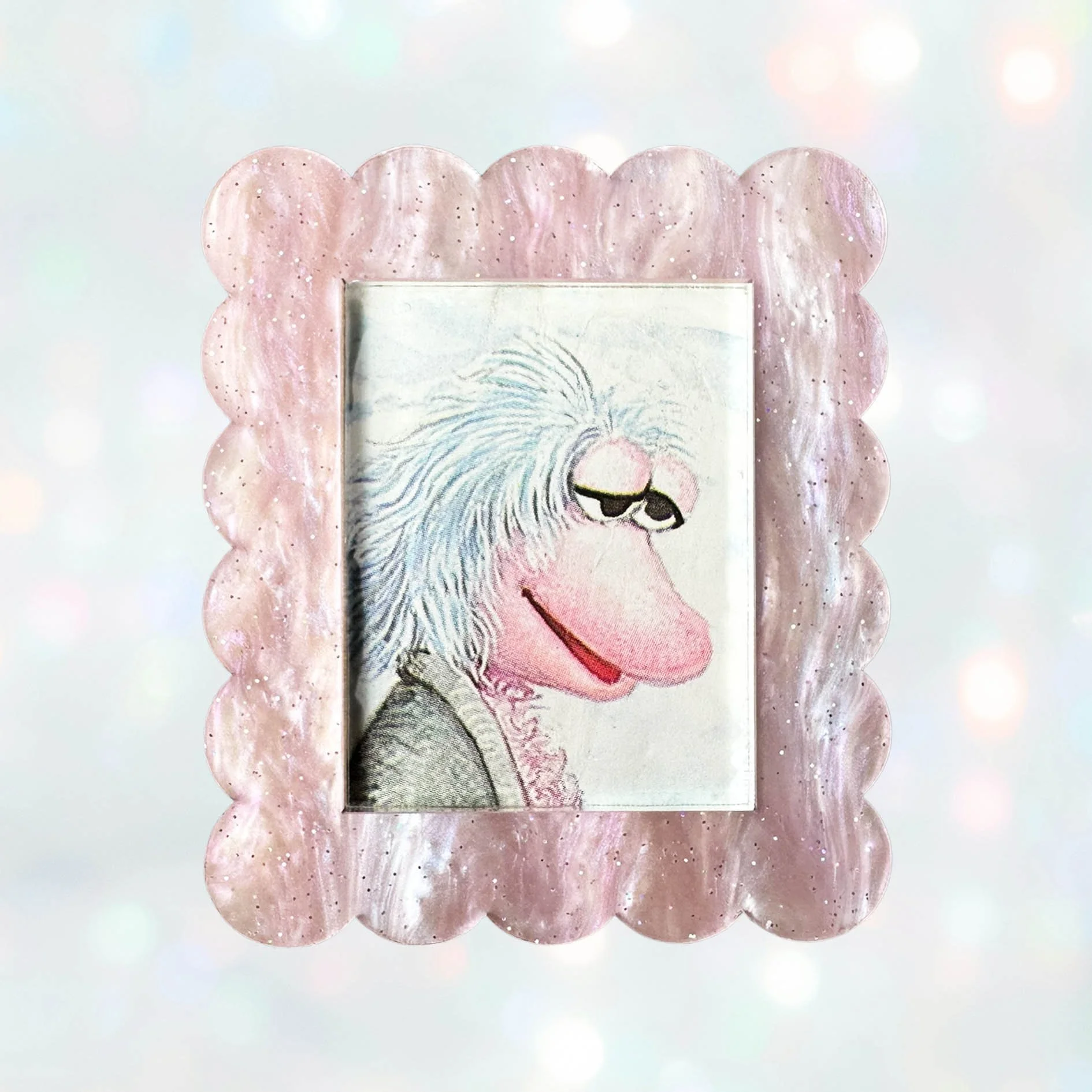 Pink glitter acrylic brooch featuring Mokey from Fraggle Rock