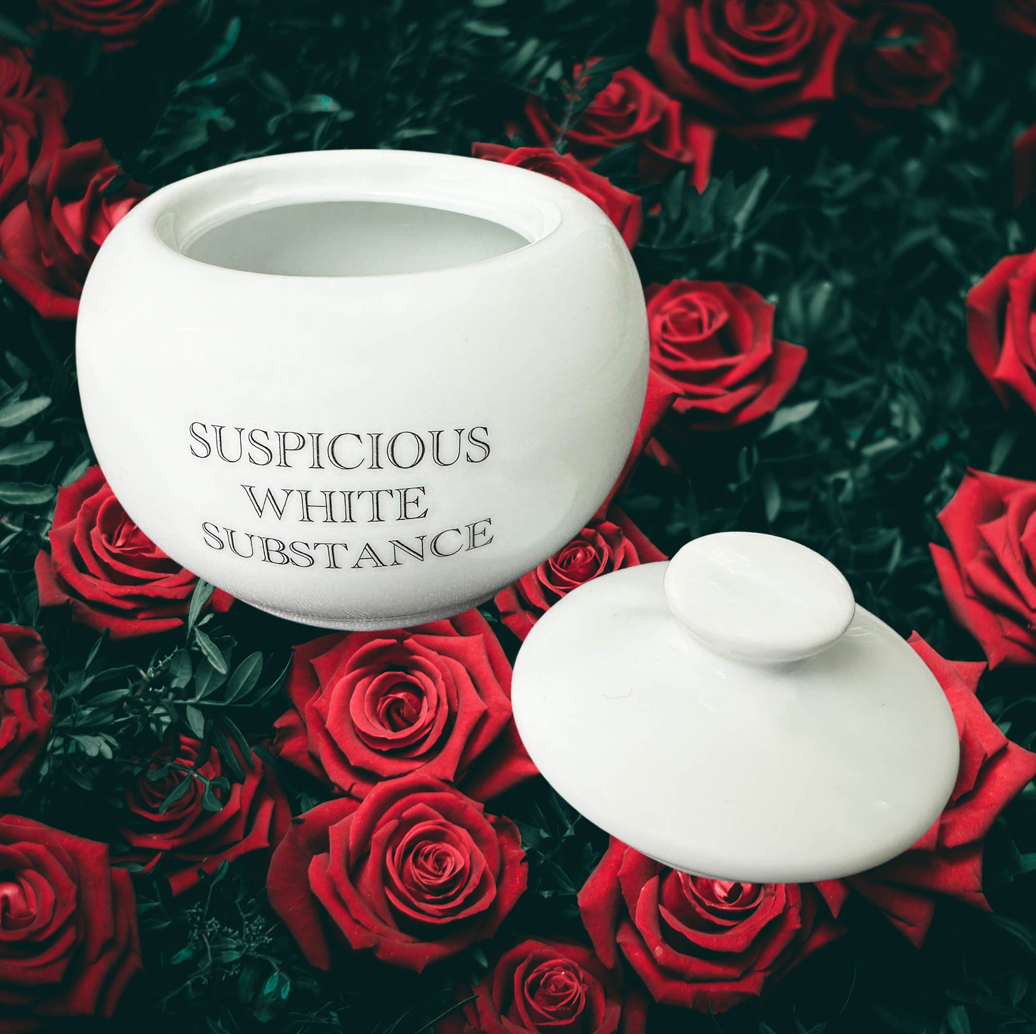 White sugar bowl with the words “suspicious white substance”in black lettering