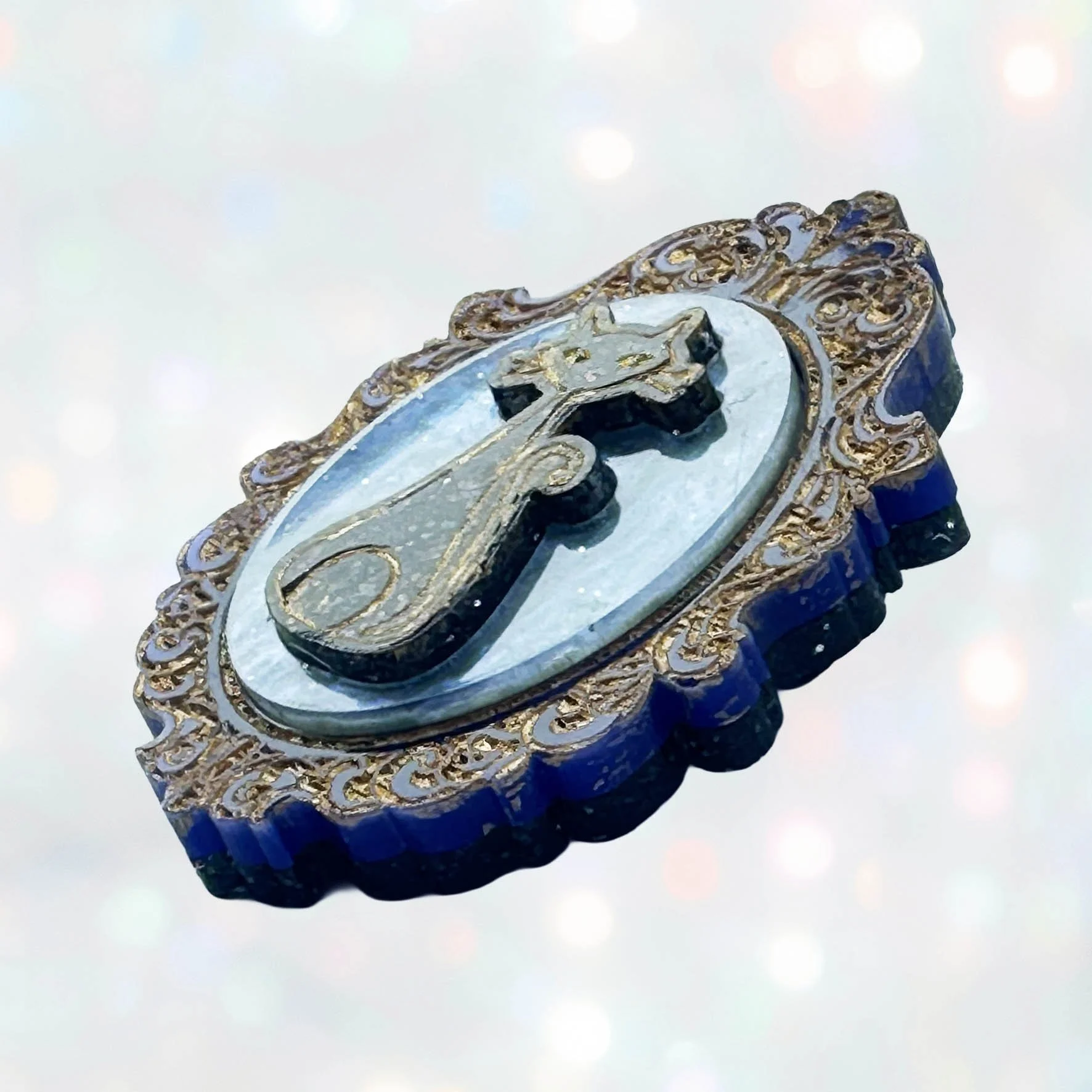 Laser cut acrylic cameo style brooch featuring black cats inside gold frames