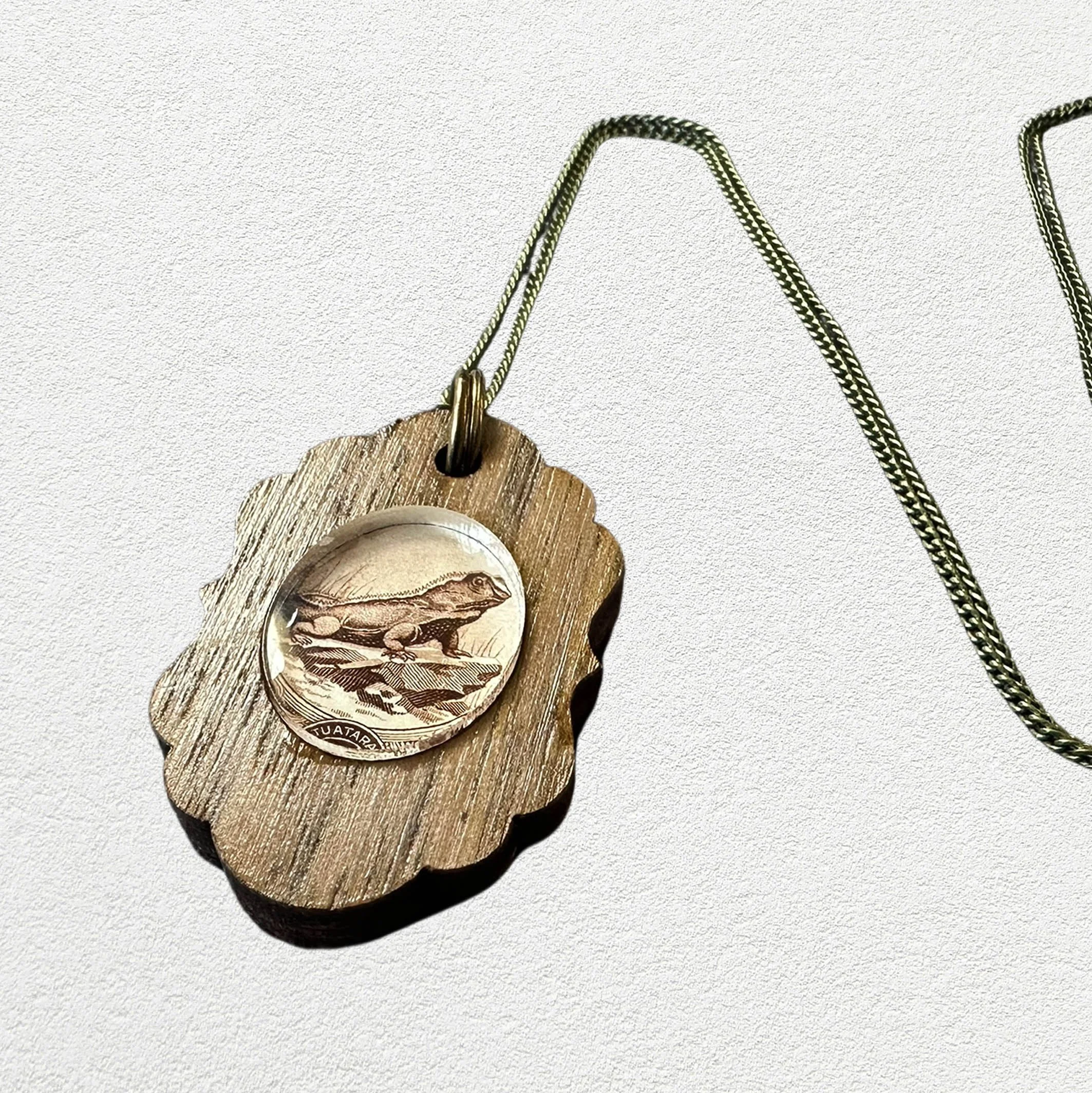 Stamp_necklace_oval_small_tuataraA4.jpg