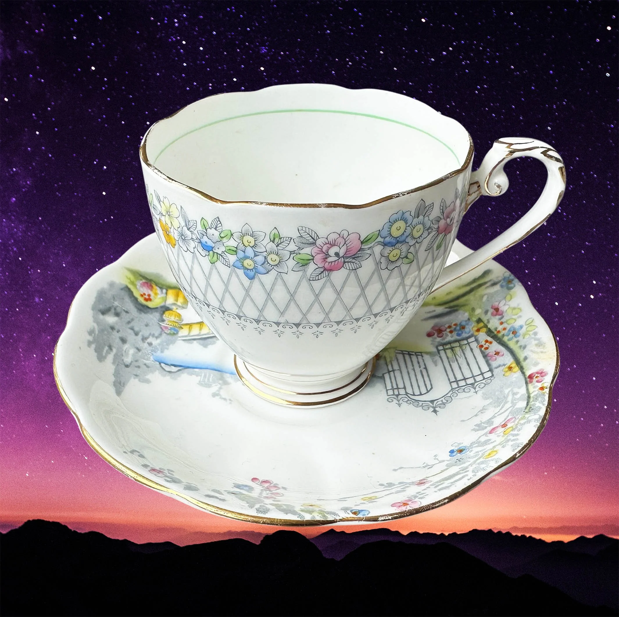 A vintage tea cup and saucer with a blue floral design and the word "Cunt" in black cursive writing