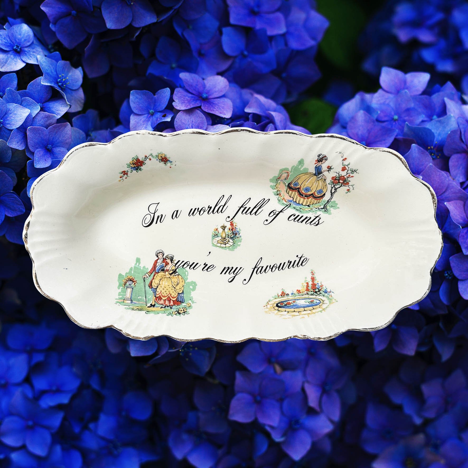 A vintage trinket dish with the quote “In a world full of cunts you’re my favourite”