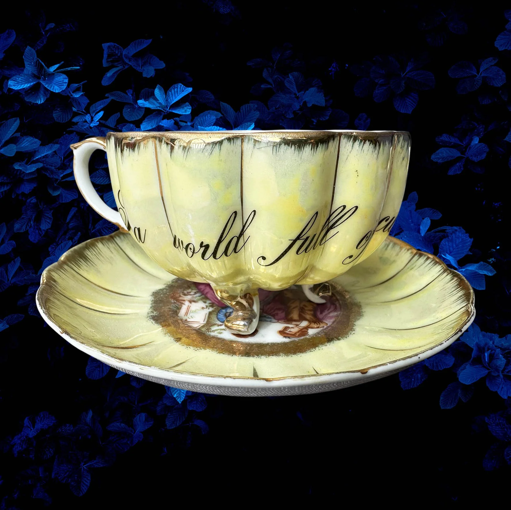 A yellow scalloped shaped tea cup with a picture of a couple and the words "In a world full of cunts you're my favourite"