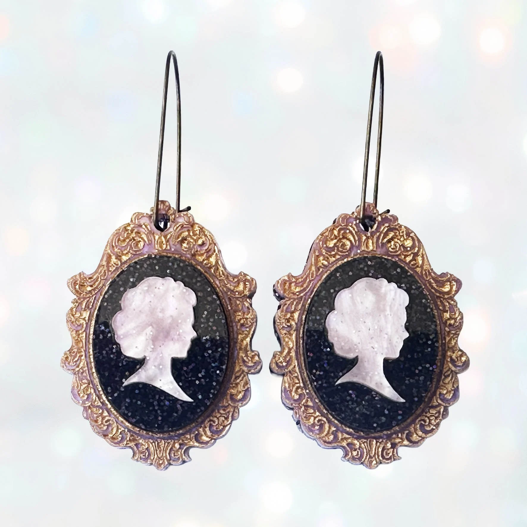 Laser cut pink and purple acrylic cameo style earrings featuring a silhouette