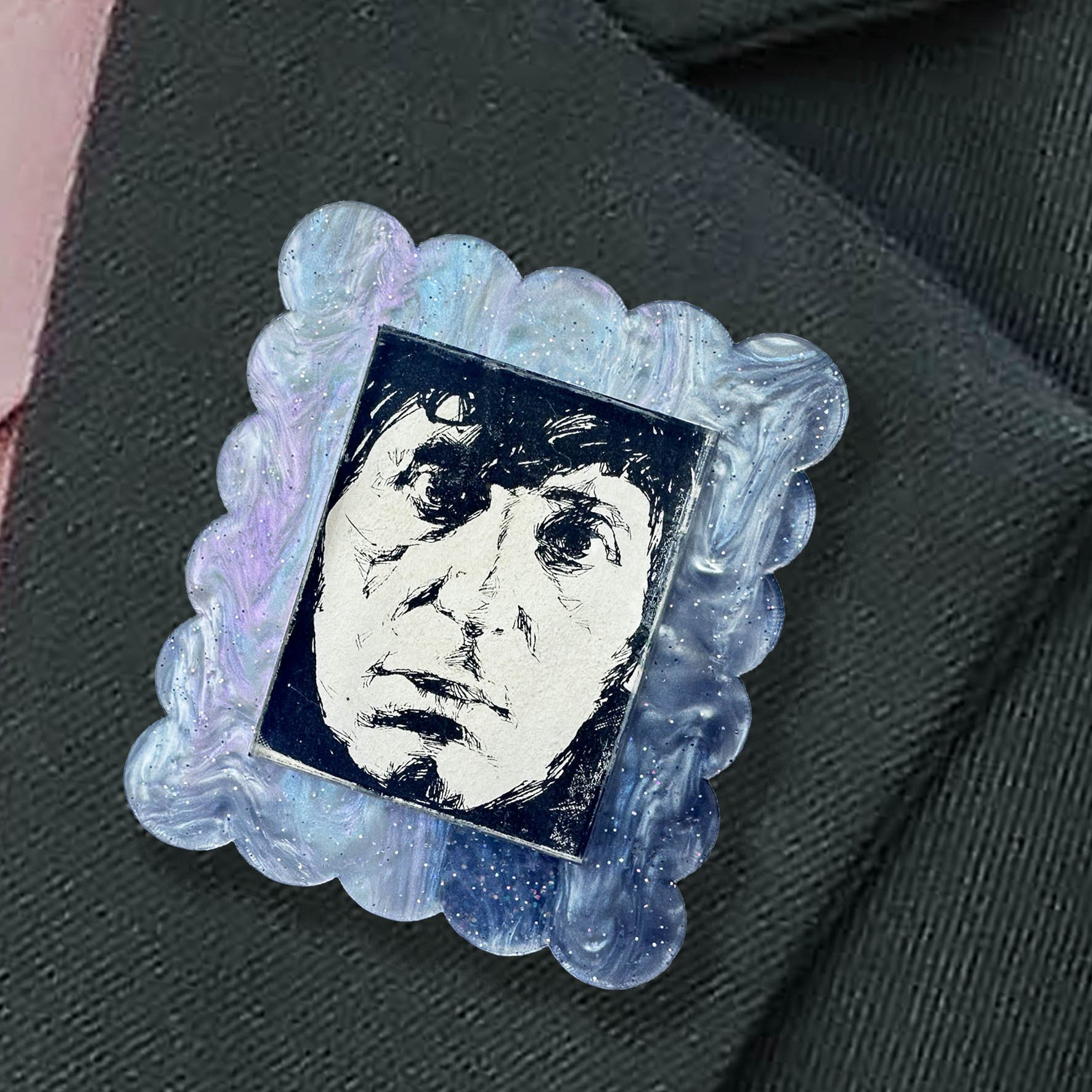 A blue purple glitter acrylic brooch featuring a picture of the 4th Doctor from Doctor Who