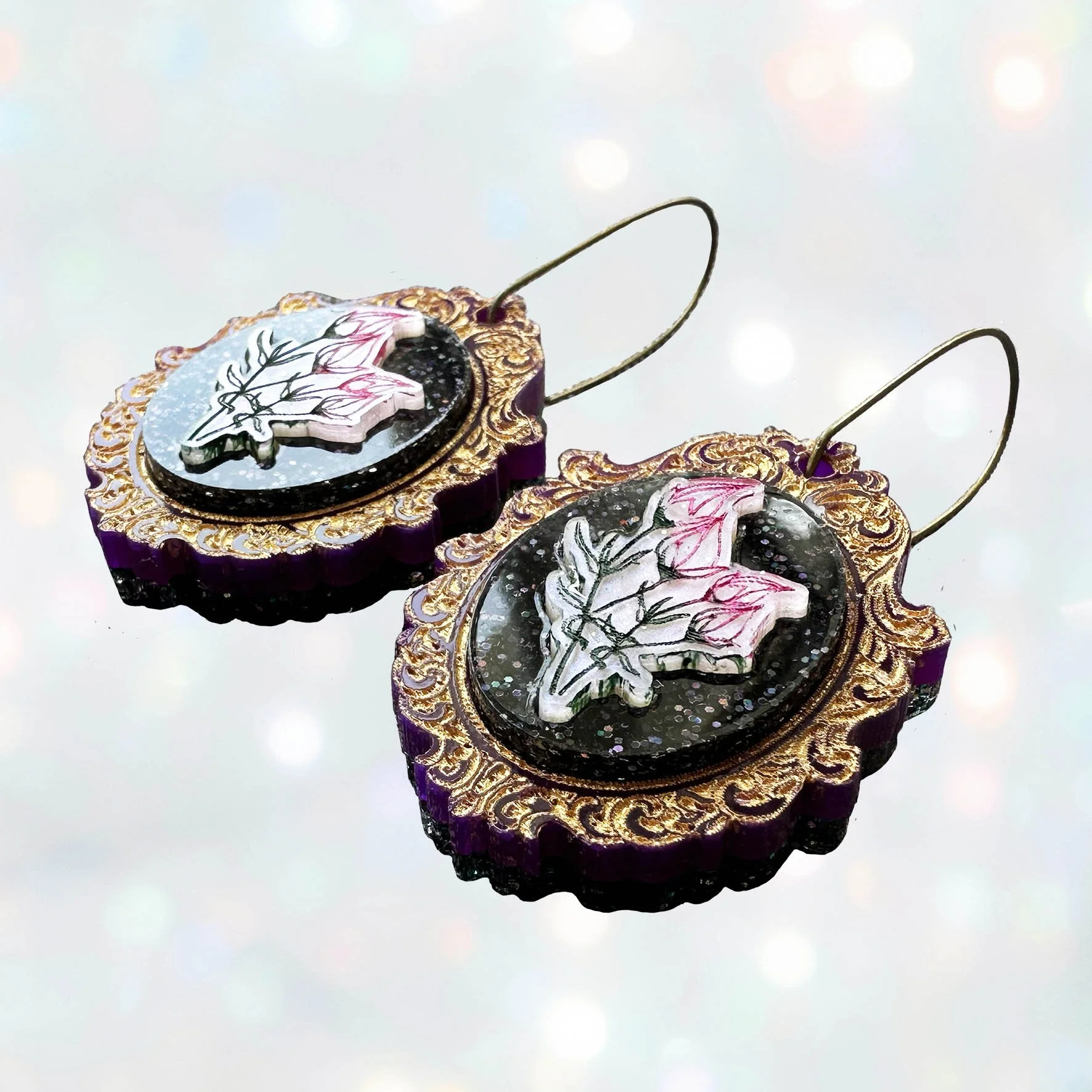 Laser cut flower earrings in cameo style frames, gold, pink and black glitter acrylic
