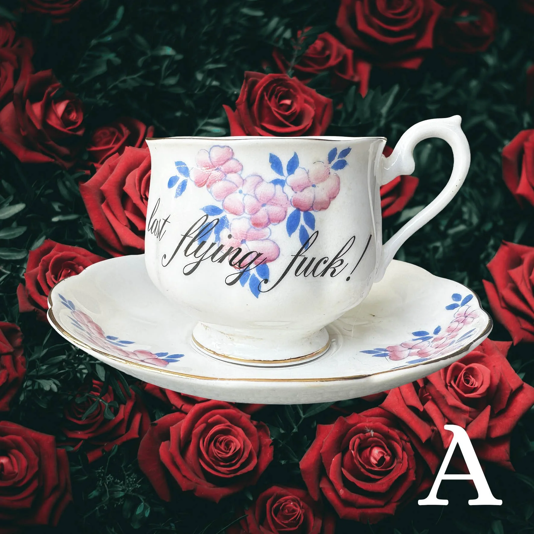 A vintage tea cup with a blue and pink floral design and the words "there it goes...my last flying fuck!"