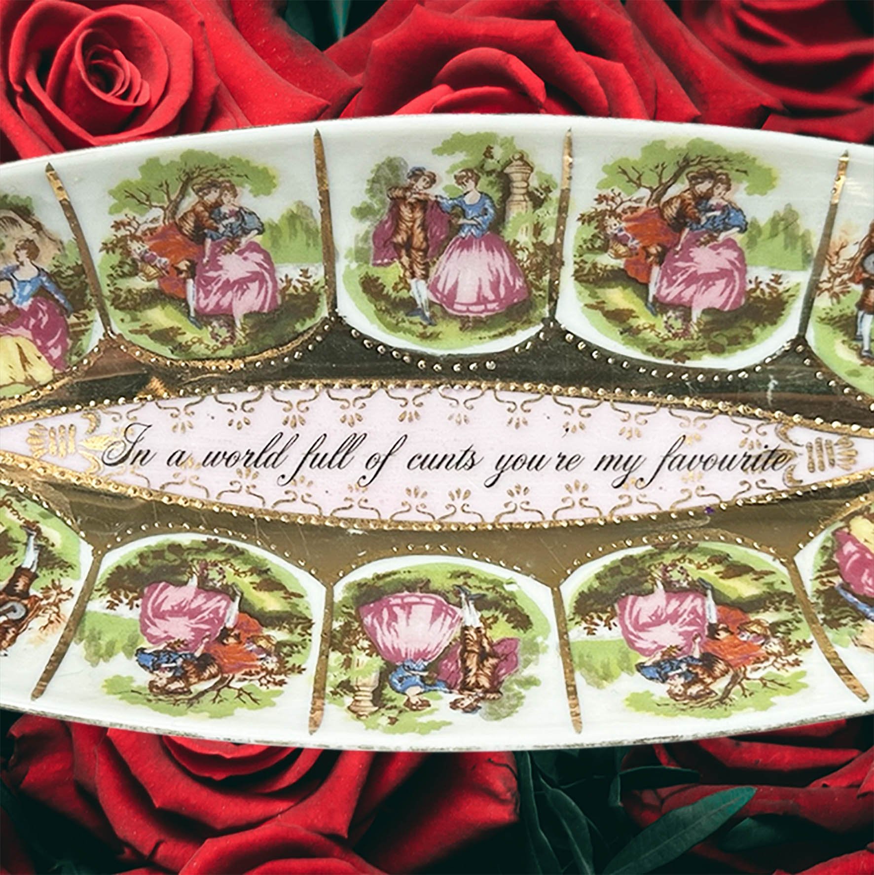 a vintage dish with pictures of a couple and the words "In a world full of cunts you're my favourite"
