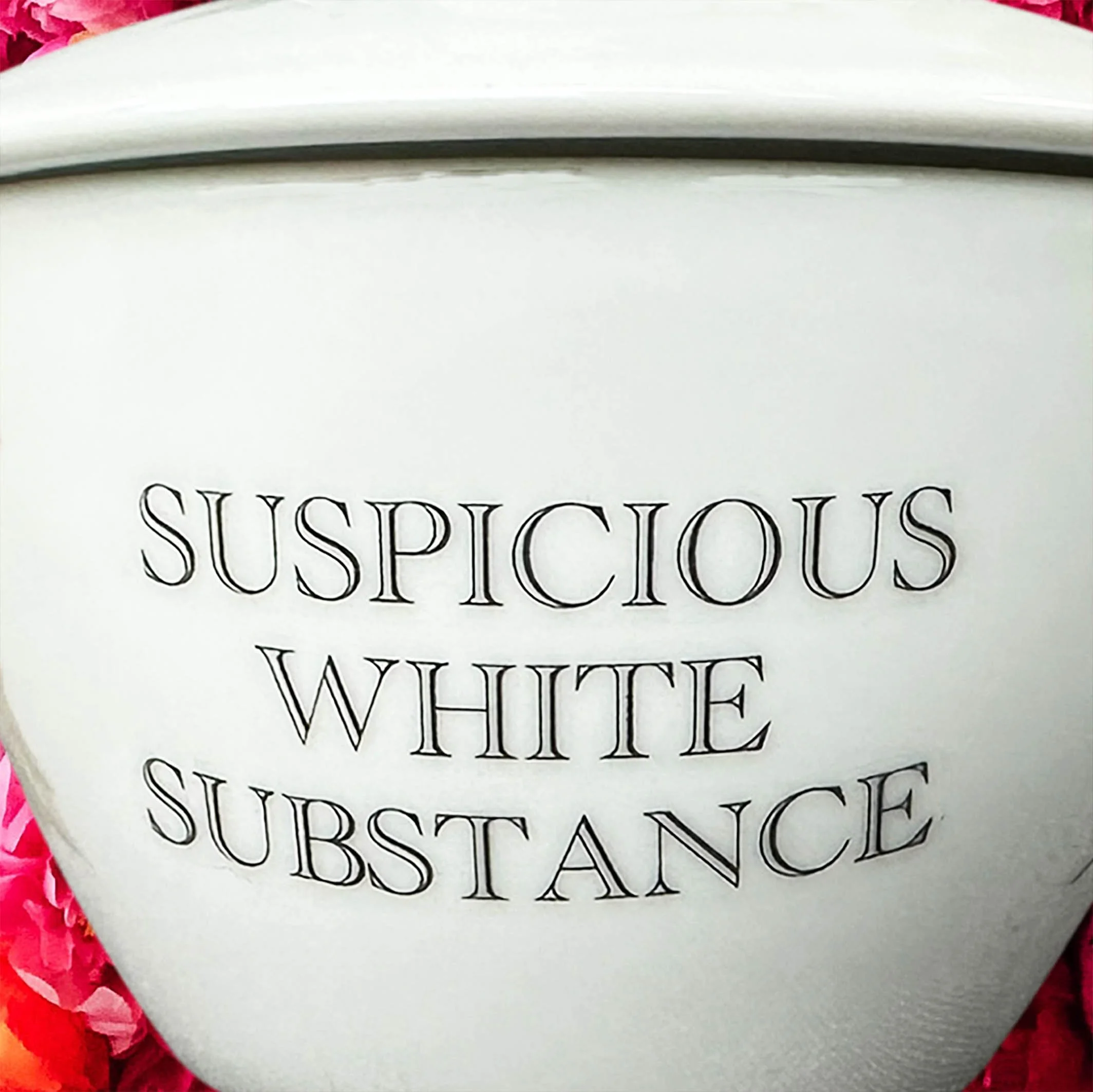 A vintage Noritake sugar bowl with a maple leaf design and the words “suspicious white substance” in black lettering