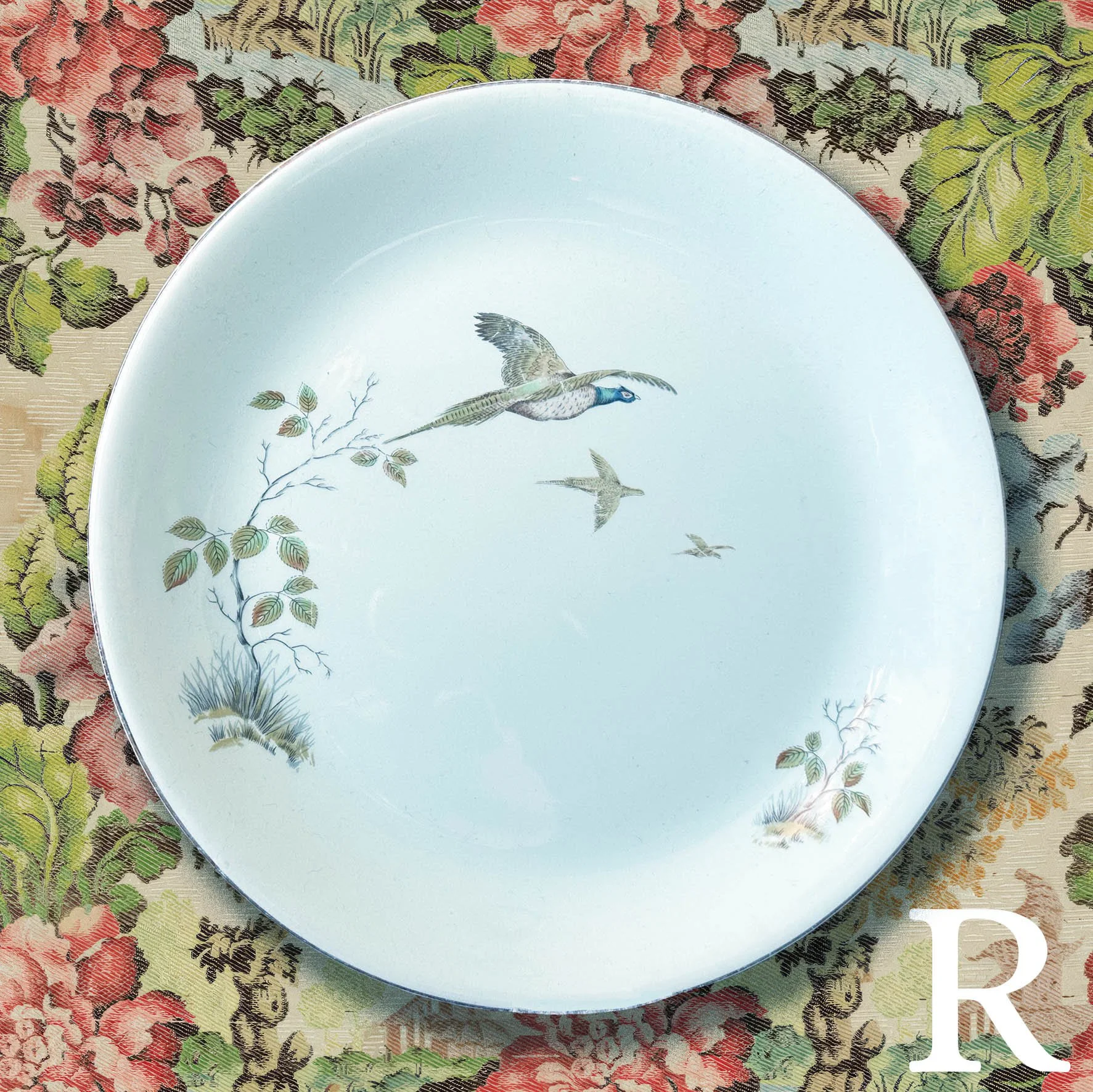 Plate R, a light greenish blue plate with flying birds