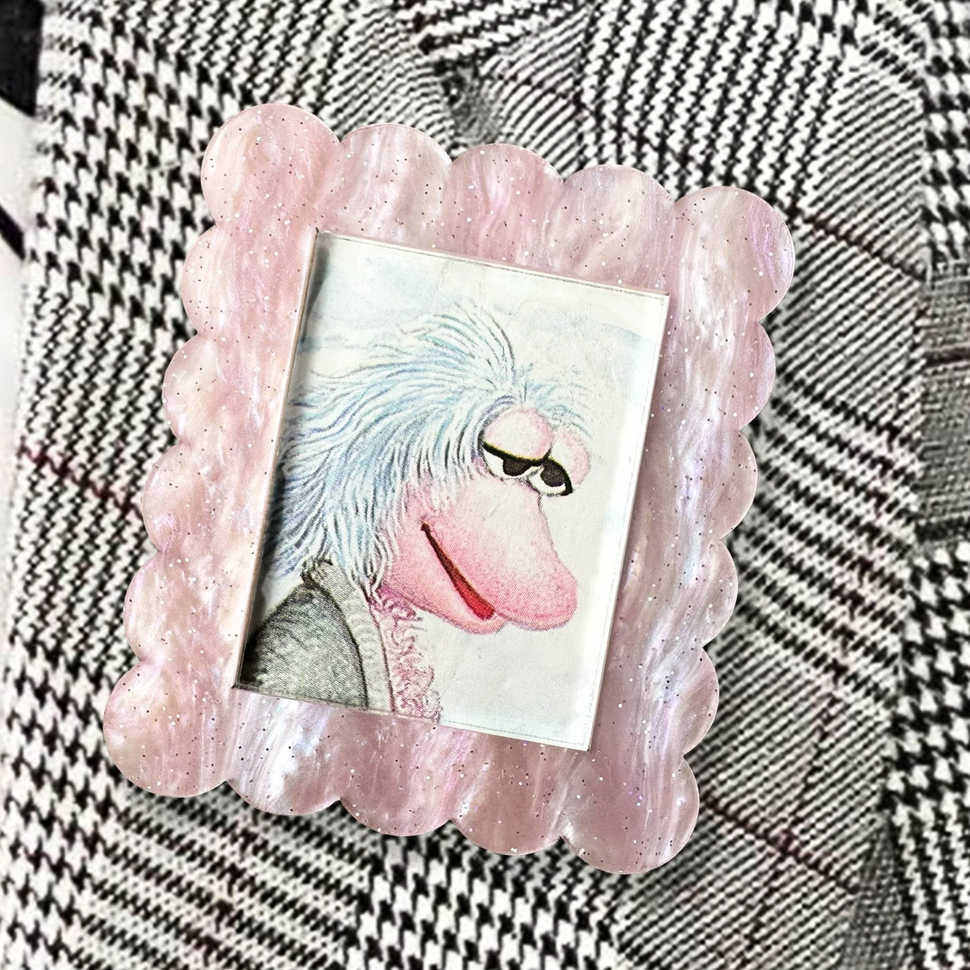 Pink glitter acrylic brooch featuring Mokey from Fraggle Rock