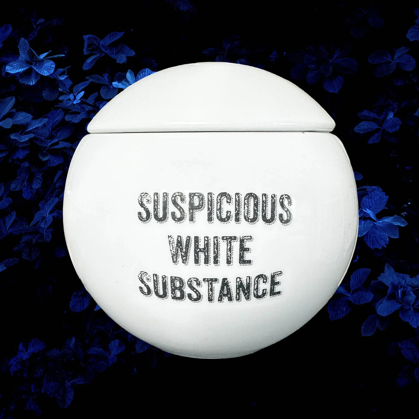 A round white sugar bowl with the words "suspicious white substance" in black lettering