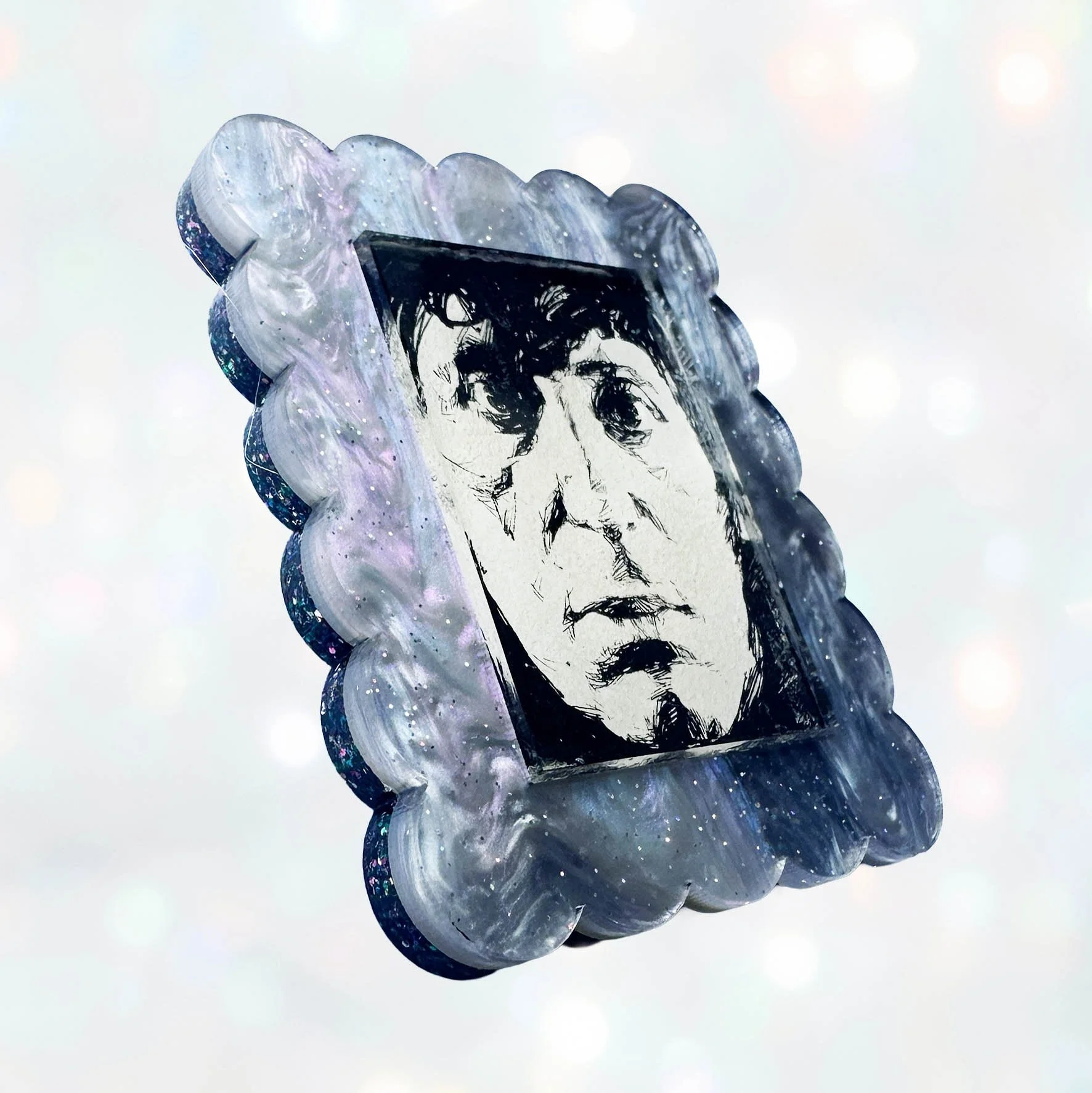 A blue purple glitter acrylic brooch featuring a picture of the 4th Doctor from Doctor Who