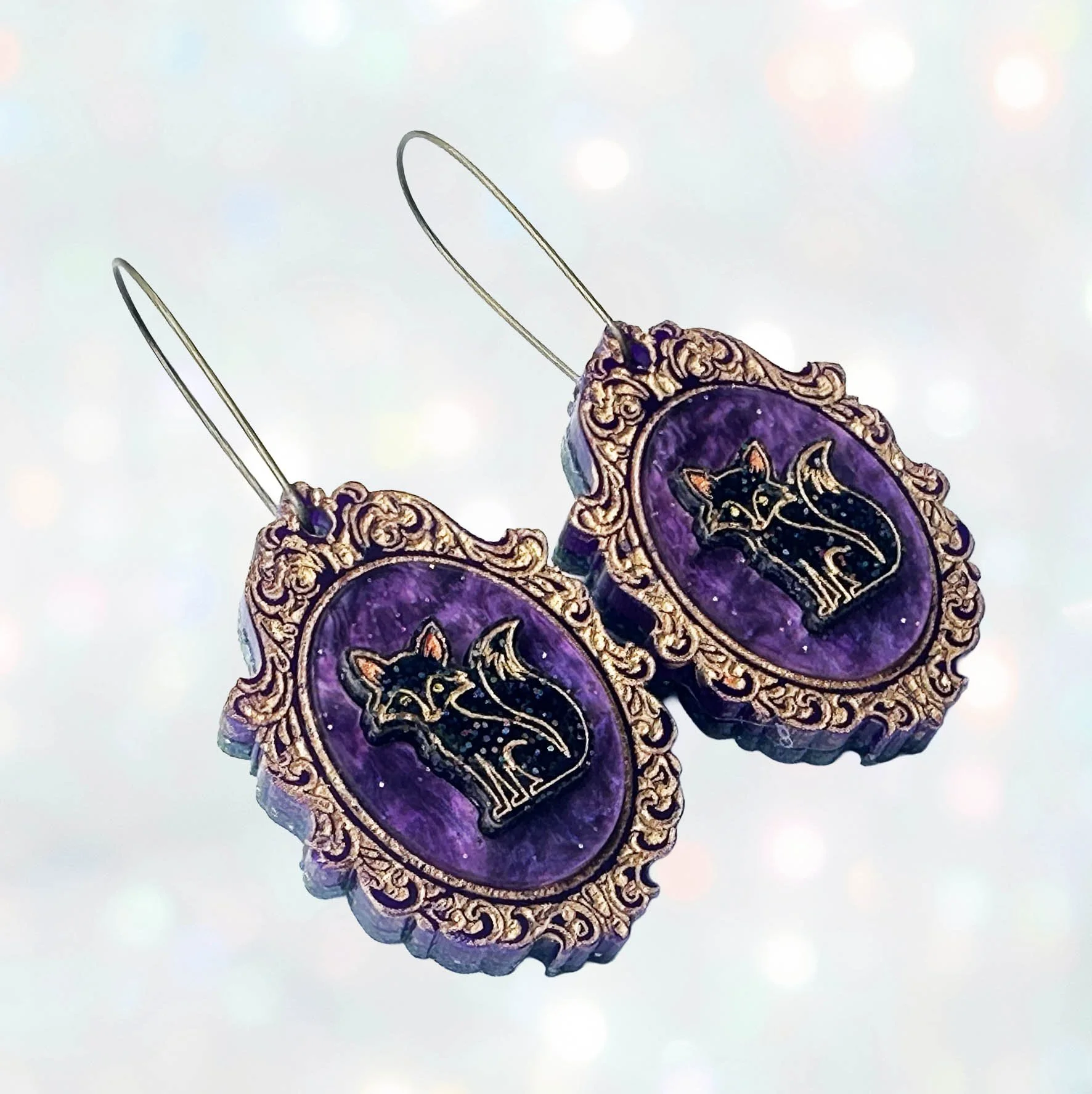 Laser cut glitter acrylic earrings featuring foxes inside gold frames