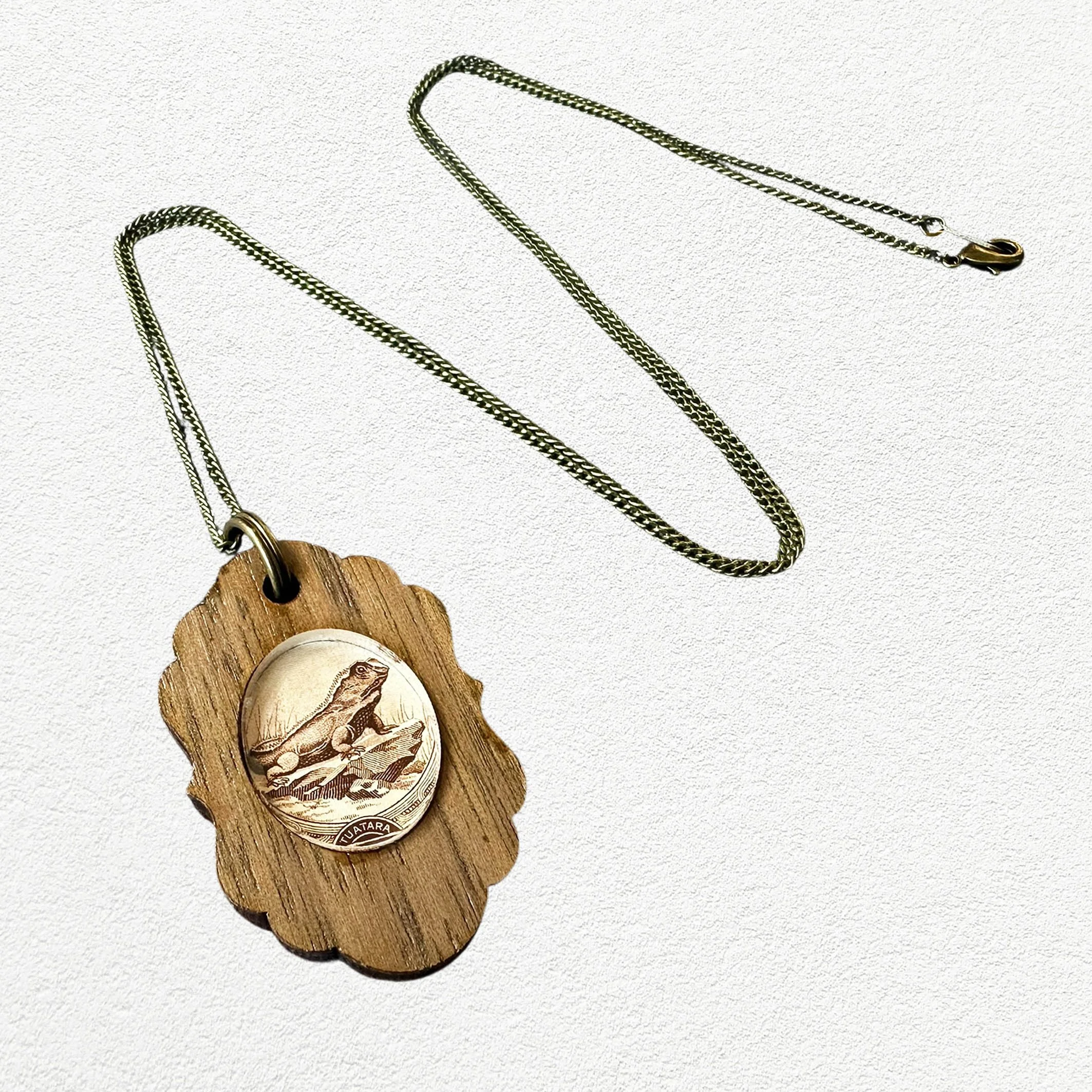 Stamp_necklace_oval_small_tuataraA3.jpg