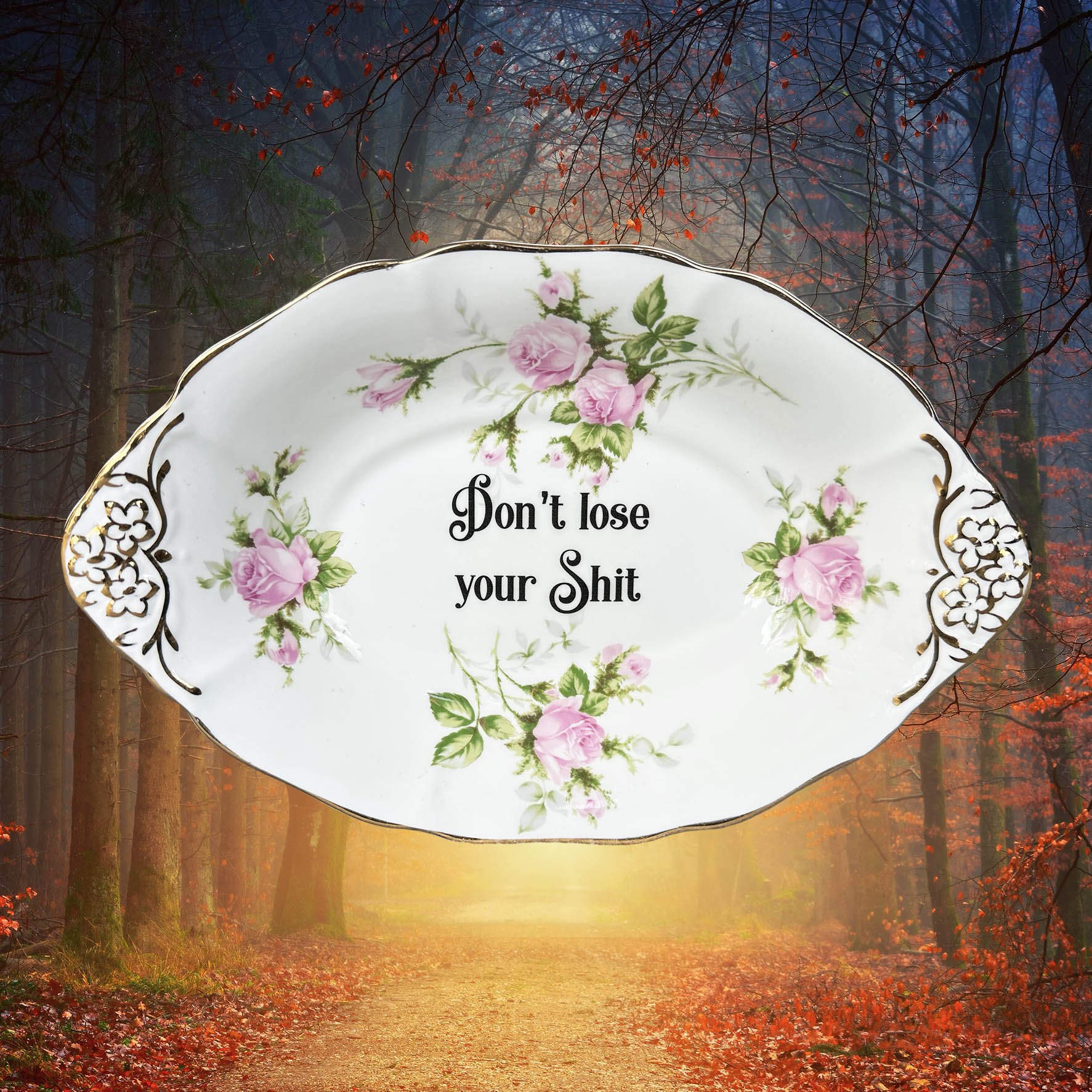 A vintage trinket dish with a pink floral design and the words “don’t lose your shit”