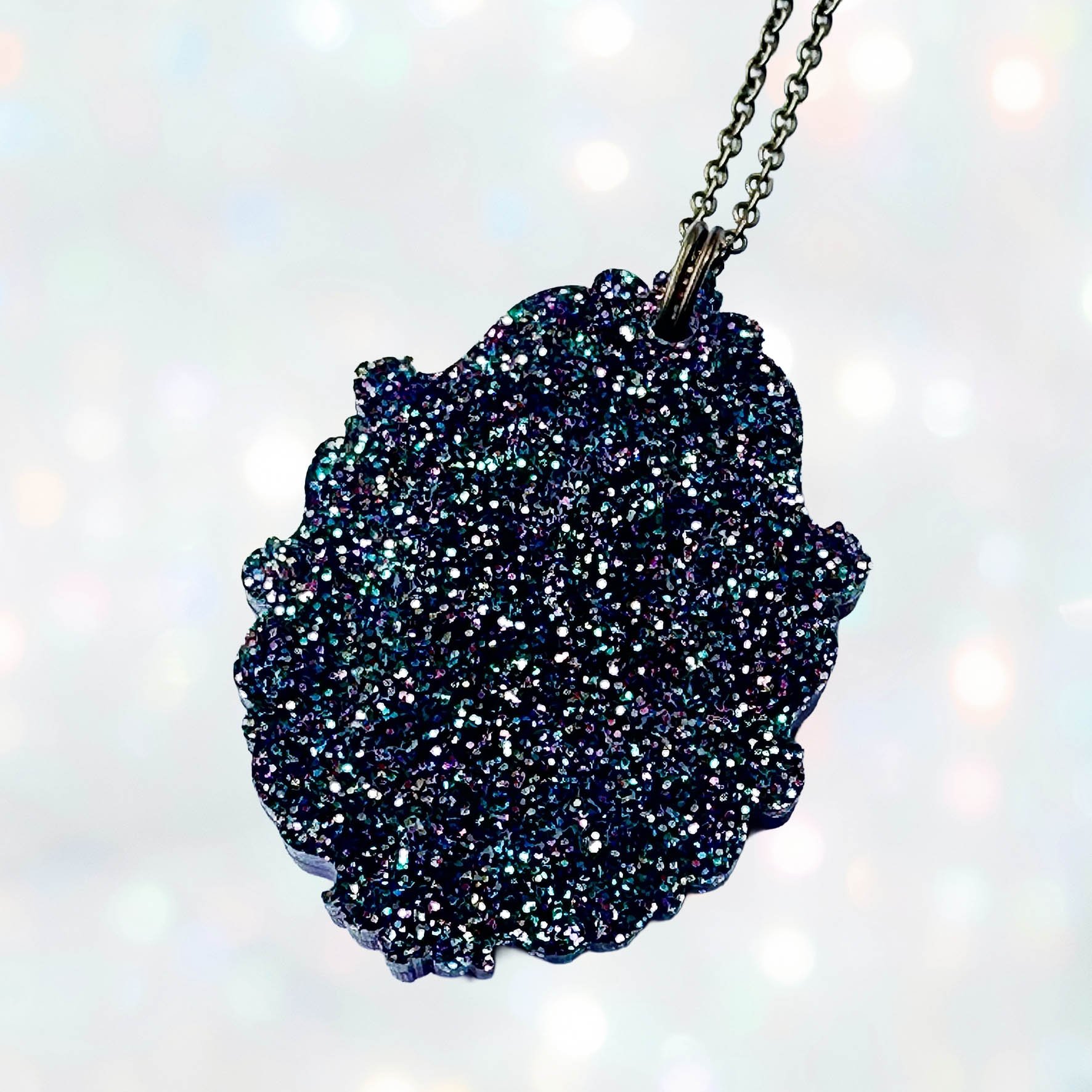 Laser cut acrylic cameo necklace featuring a bunch of flowers inside a gold frame