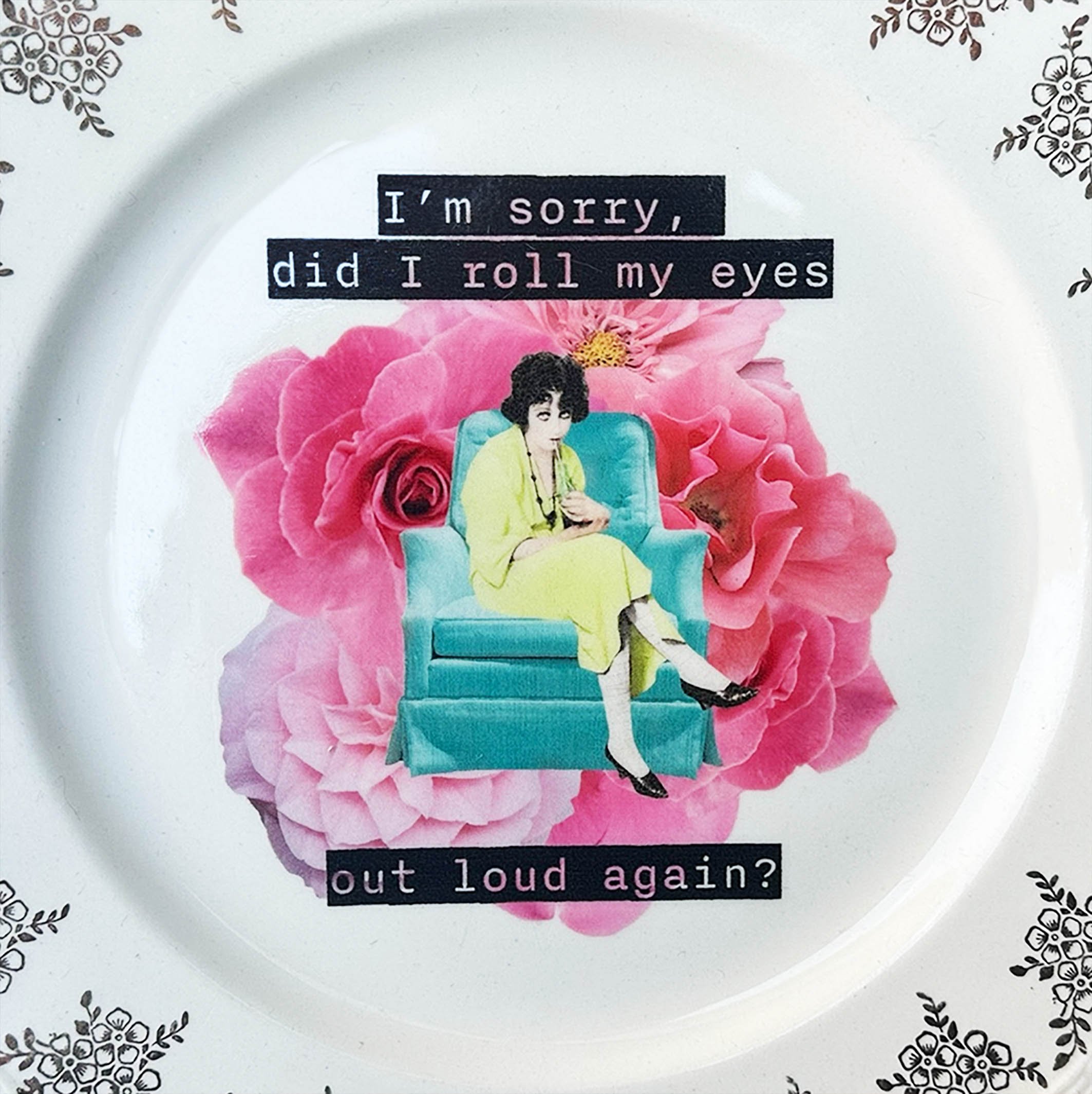 I’m sorry did I roll my eyes out loud again? Decorative wall plate, vintage plate with a floral border, an image of a woman sitting on a green chair rolling her eyes