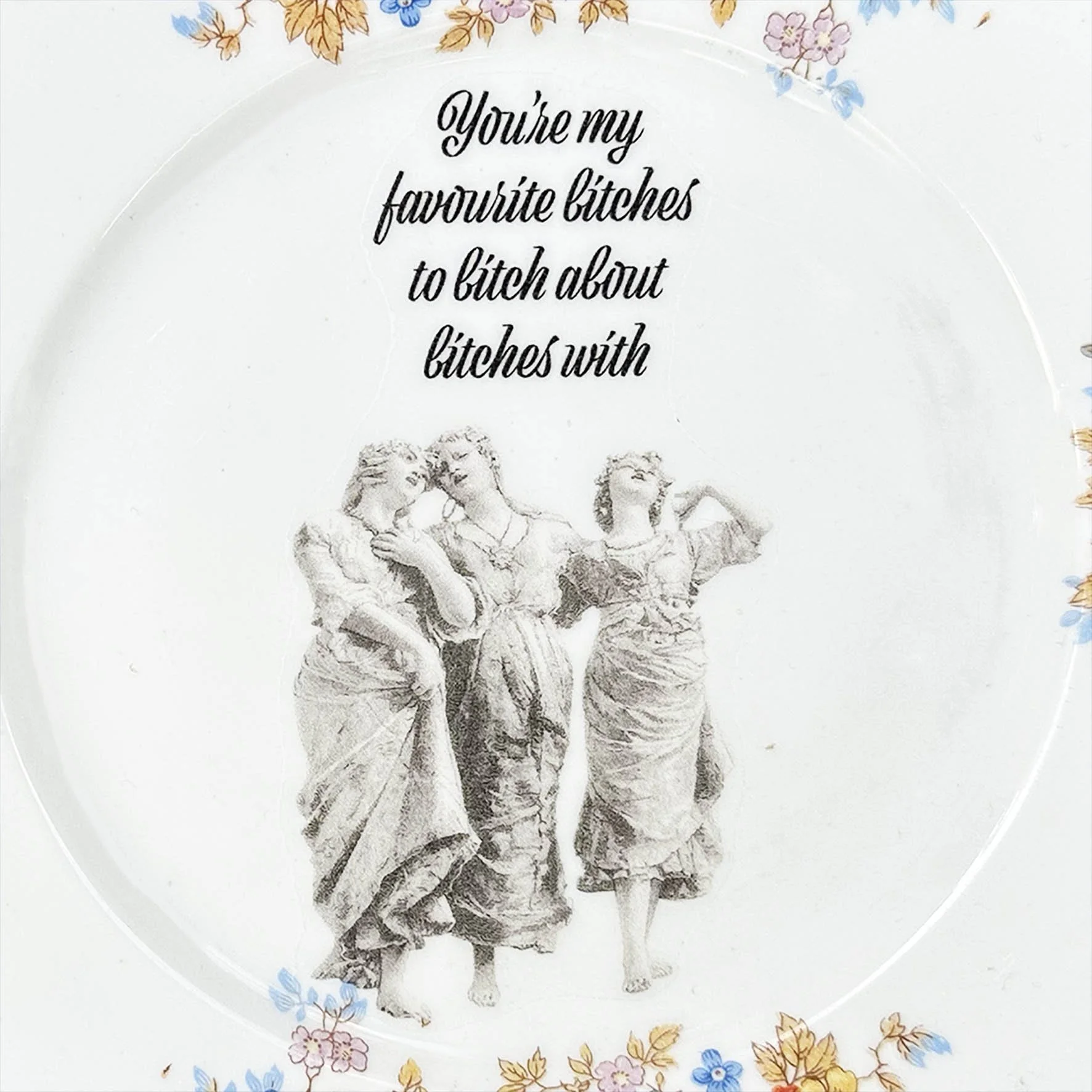 Vintage plate with blue flowers and the image of three women, black writing “you’re my favourite bitches to bitch about bitches with”