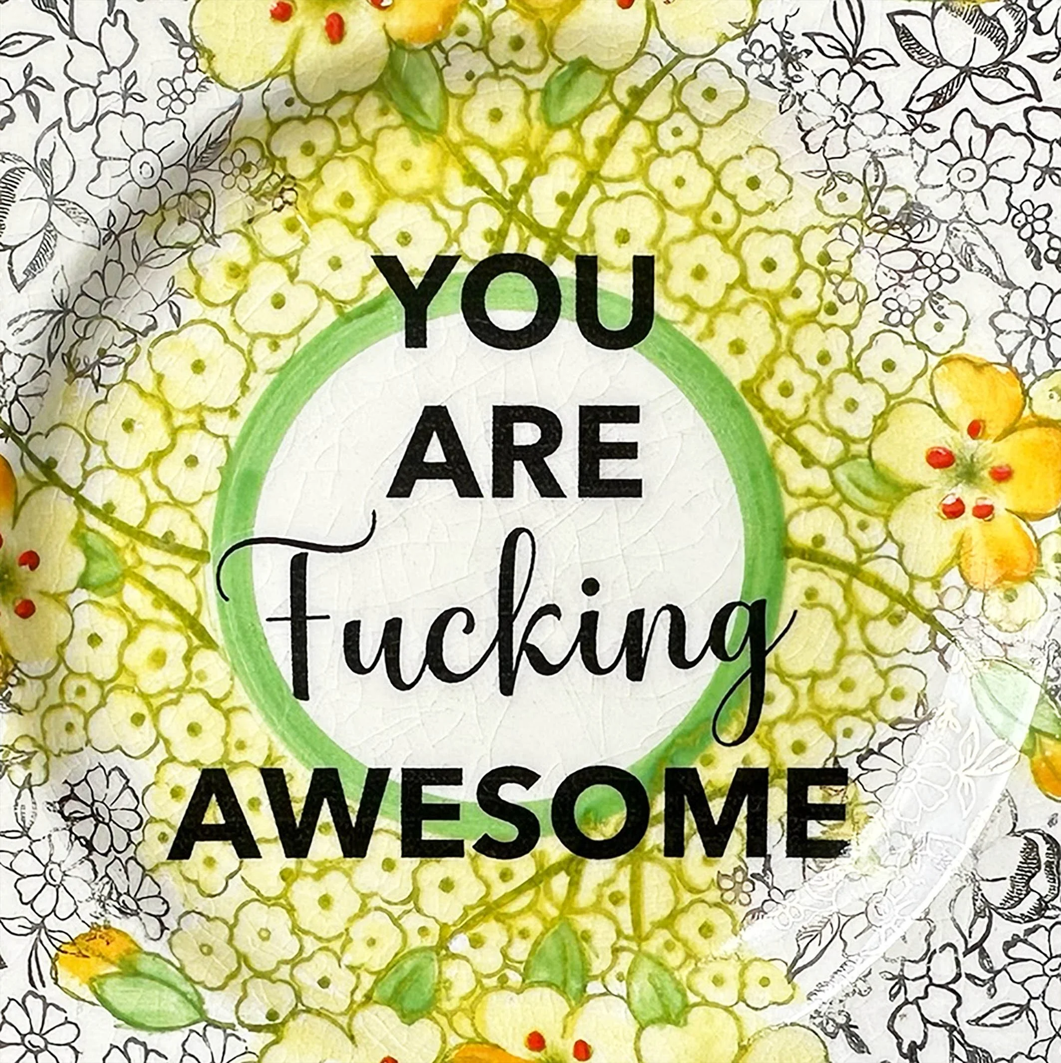 A vintage plate with a yellow and gold floral design and the words “you are fucking awesome” in black lettering